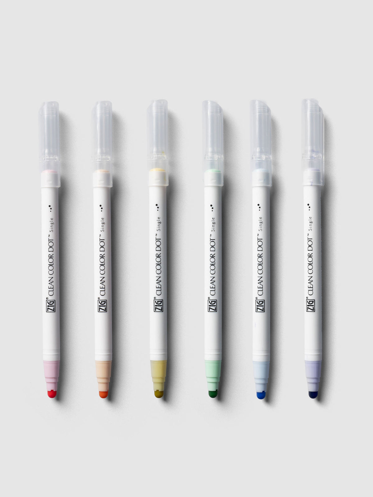 Mild Colors set of six Kuretake ZIG Clean Color Dot Markers lined up with caps on: Baby Pink, Peach Bliss, Butter, Pale Mint, Powder Blue and English Lavender.
