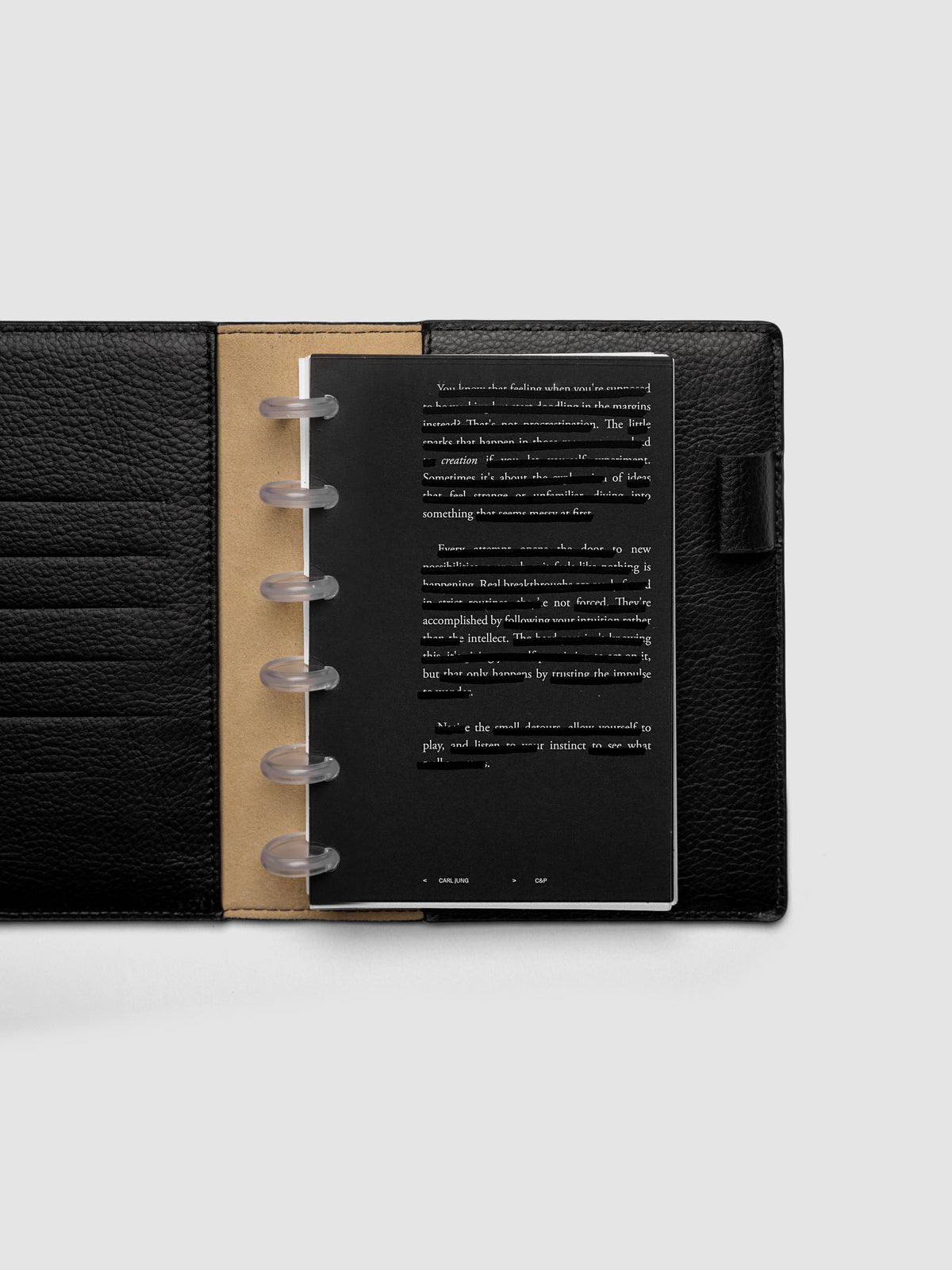 Black, white, and transparent dual layer planner dashboard shown in size CP Petite 6-Disc Punch inside a planner