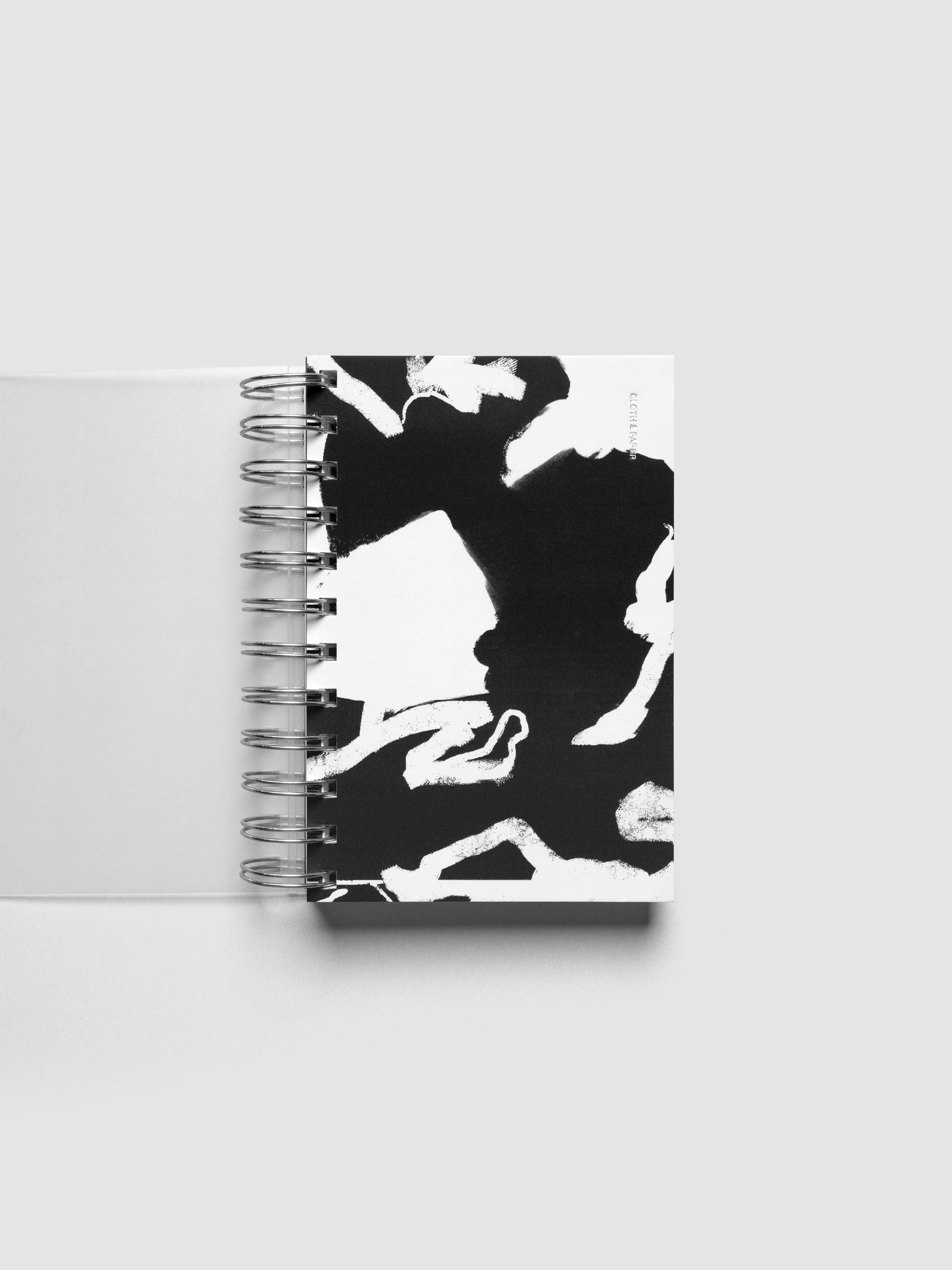 Spiral Notebook dashboard in the pattern Drybrush shown in size CP Petite inside a notebook.