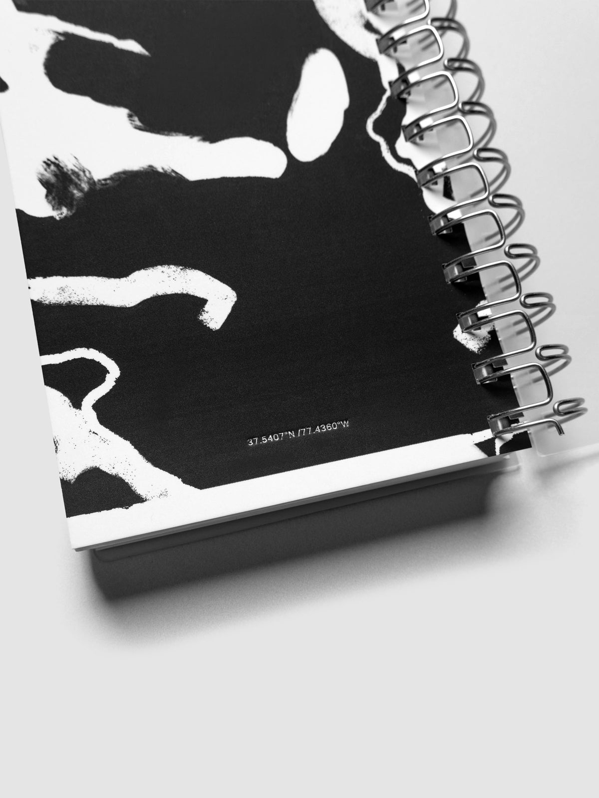 Detail view of the Spiral Notebook dashboard in the pattern Drybrush shown in size CP Petite against a neutral background.