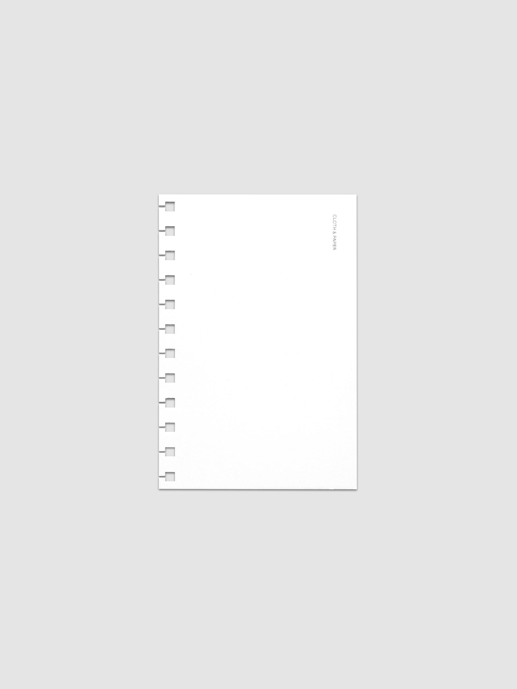 Spiral Notebook dashboard in the color Le Blanc shown in size CP Petite against a neutral background.