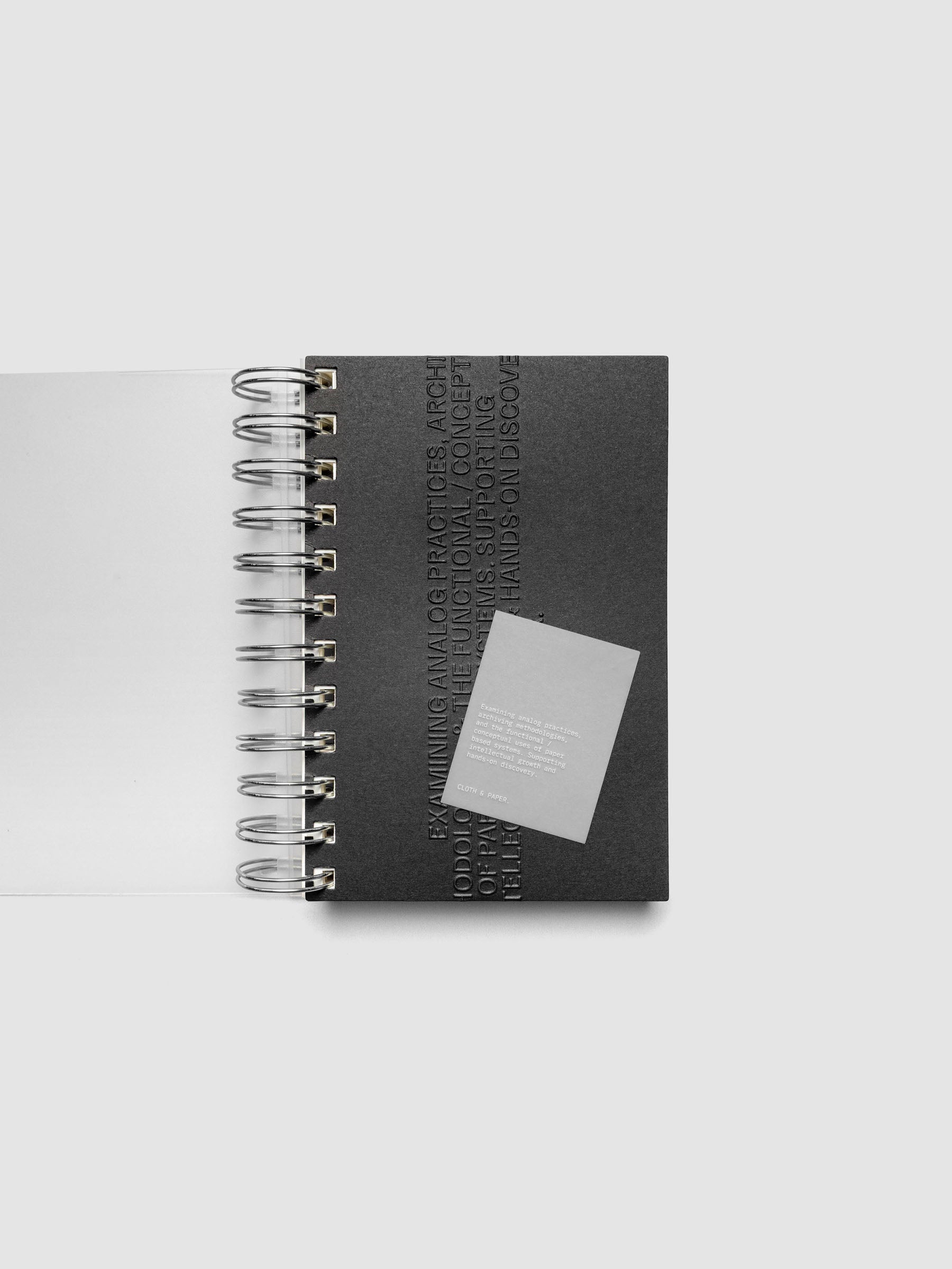 Black embossed Analog Embossed Planner Dashboard with drop card shown in size CP Petite Spiral.