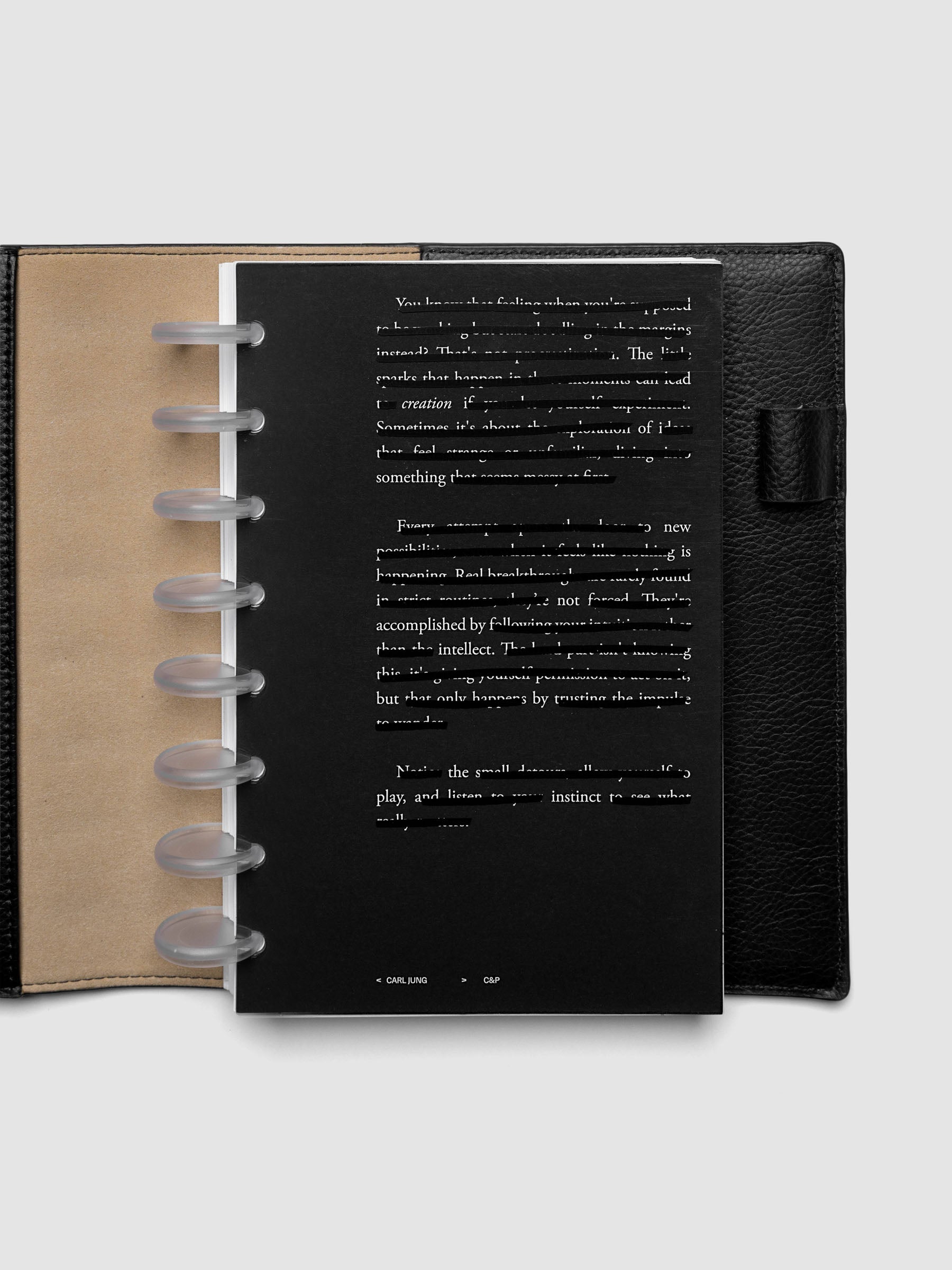 Black, white, and transparent dual layer planner dashboard shown in size Half Letter 8-Disc Punch inside a planner
