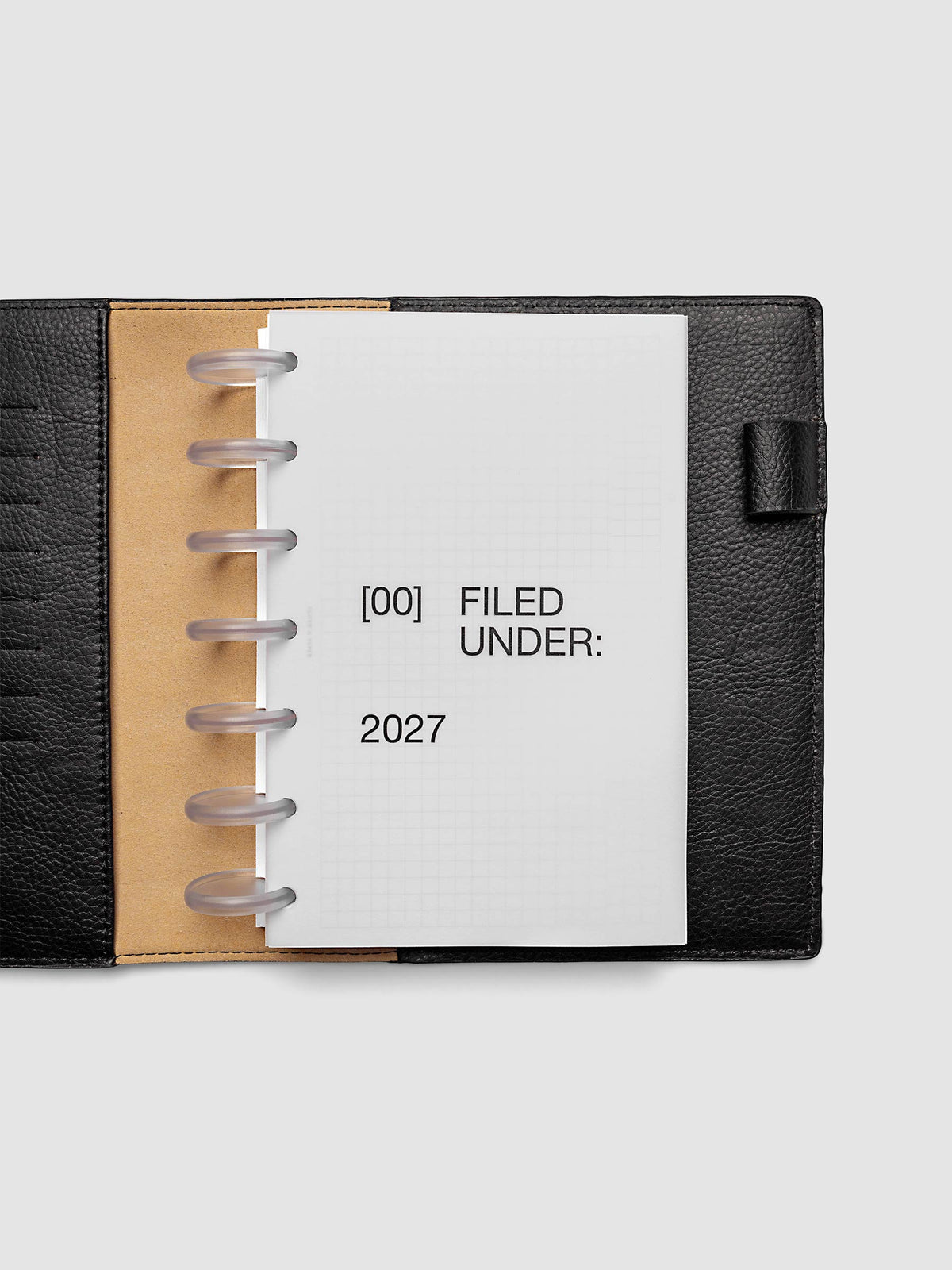 2027 Front + Monthly Dashboard Overlays, Avant Garde, HP Mini 7-Disc Punch, vellum dashboard overlay shown layered inside a planner