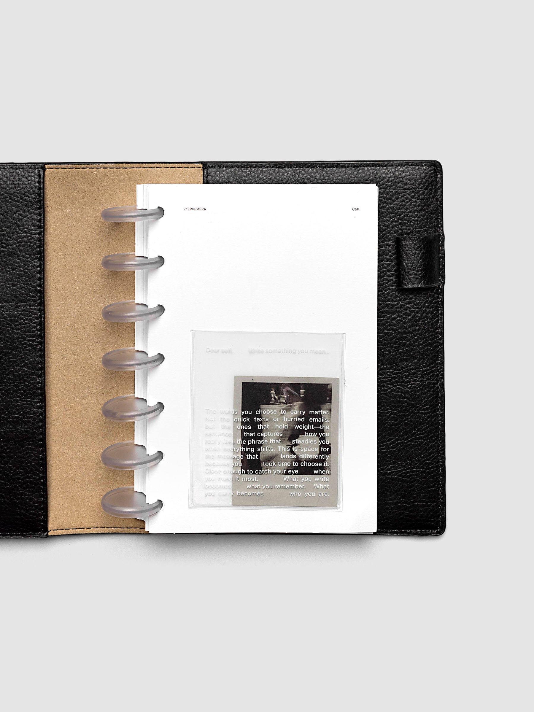 White Ephemera Planner Dashboard shown in size HP Mini in a black leather folio.