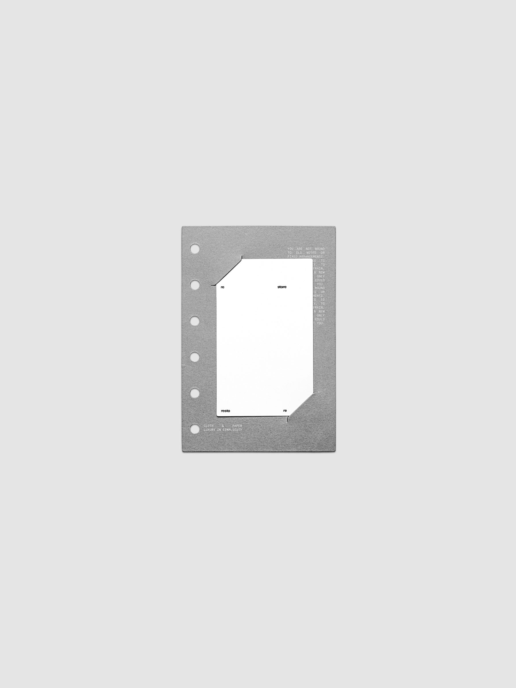 Grey cardstock planner dashboard with white plastic card inserted in slits with white printed text shown in size Pocket for ring bound planners.
