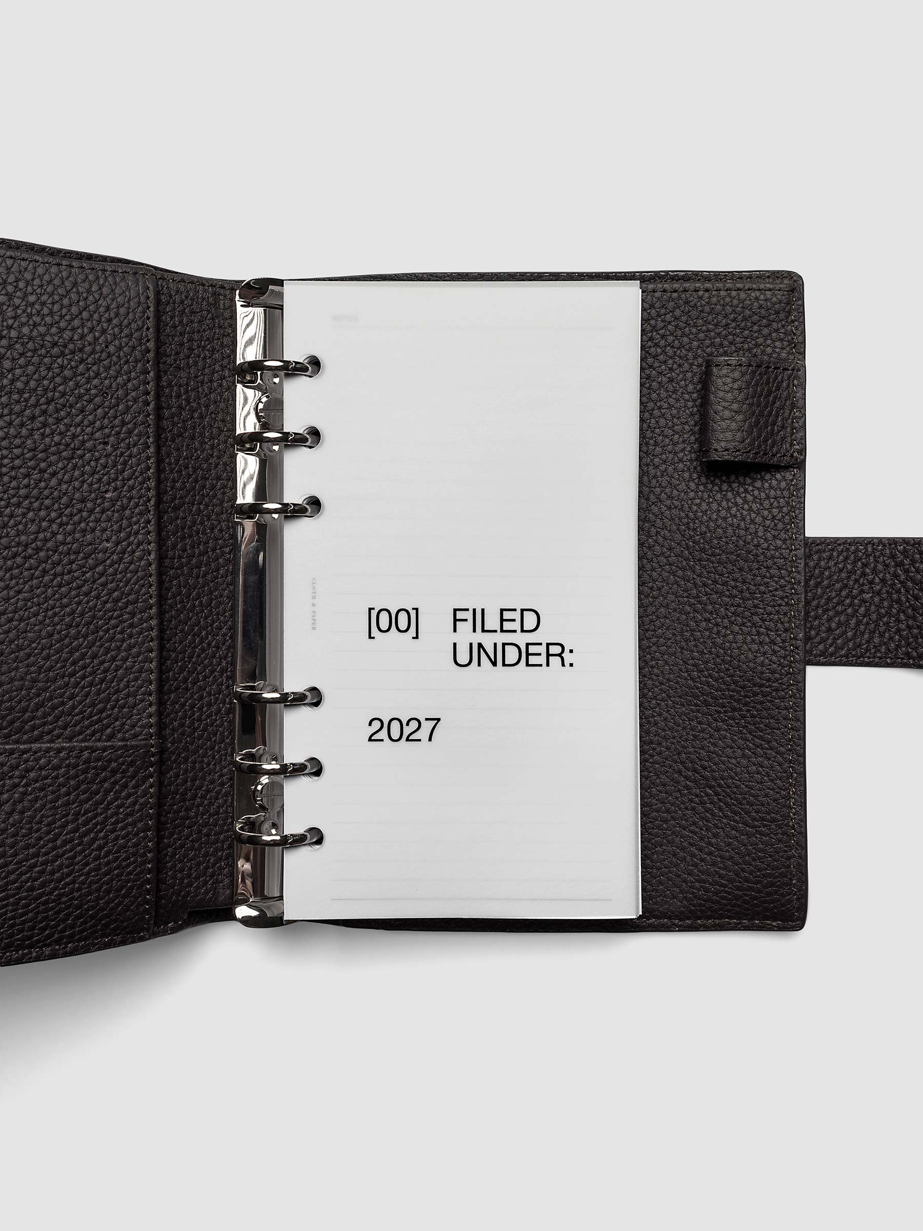2027 Front + Monthly Dashboard Overlays, Avant Garde, Personal 6-Ring Punch, vellum dashboard overlay shown layered inside a planner