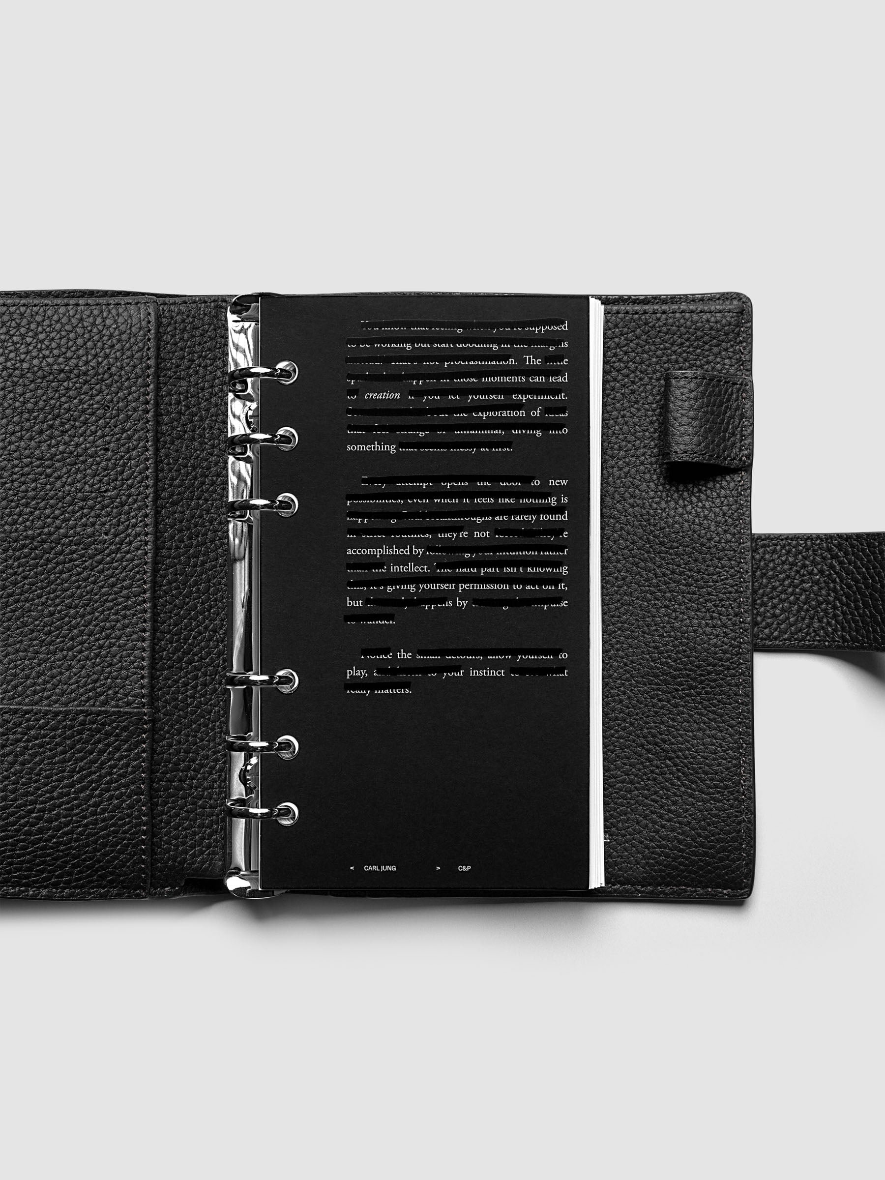 Black, white, and transparent dual layer planner dashboard shown in size Personal 6-Ring Punch inside a planner