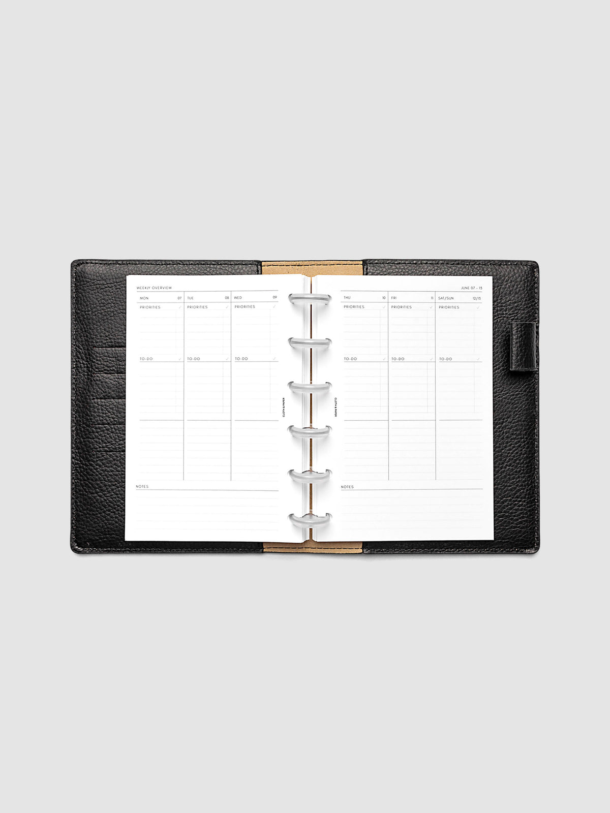 Both pages inside planner: 2027 Dated Weekly Task Planner Inserts, Monday Start, CP Petite 6-Disc Punch, full week-on-two-pages spread showing blank vertical columns for each day with labeled priorities, to-do, and notes sections, Saturday and Sunday combined, and weekly notes section along the bottom, shown inside a planner