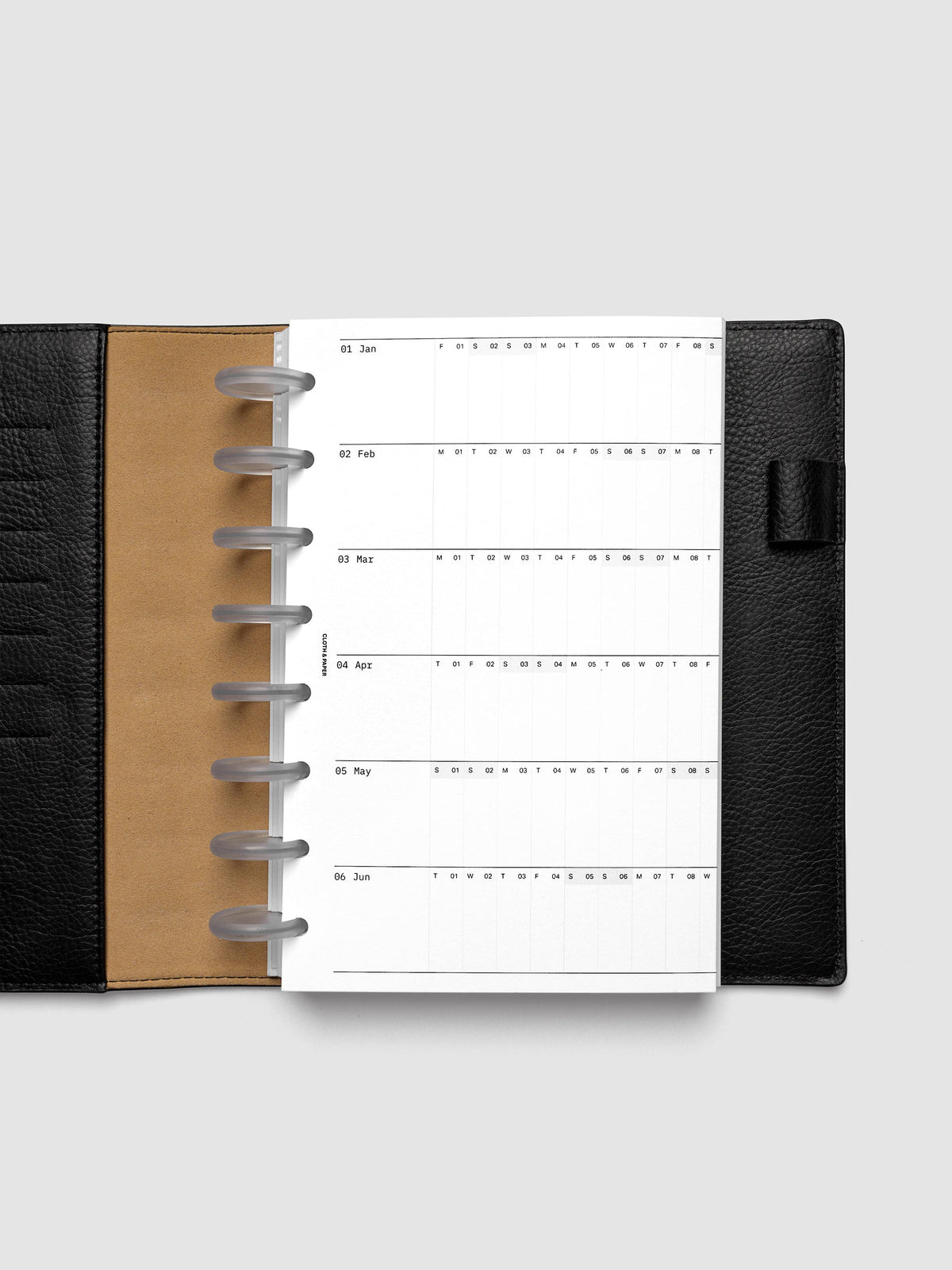 2027 Dated Fold Out Insert tucked into a Half Letter 8-Disc Punch discbound planner, shown closed.