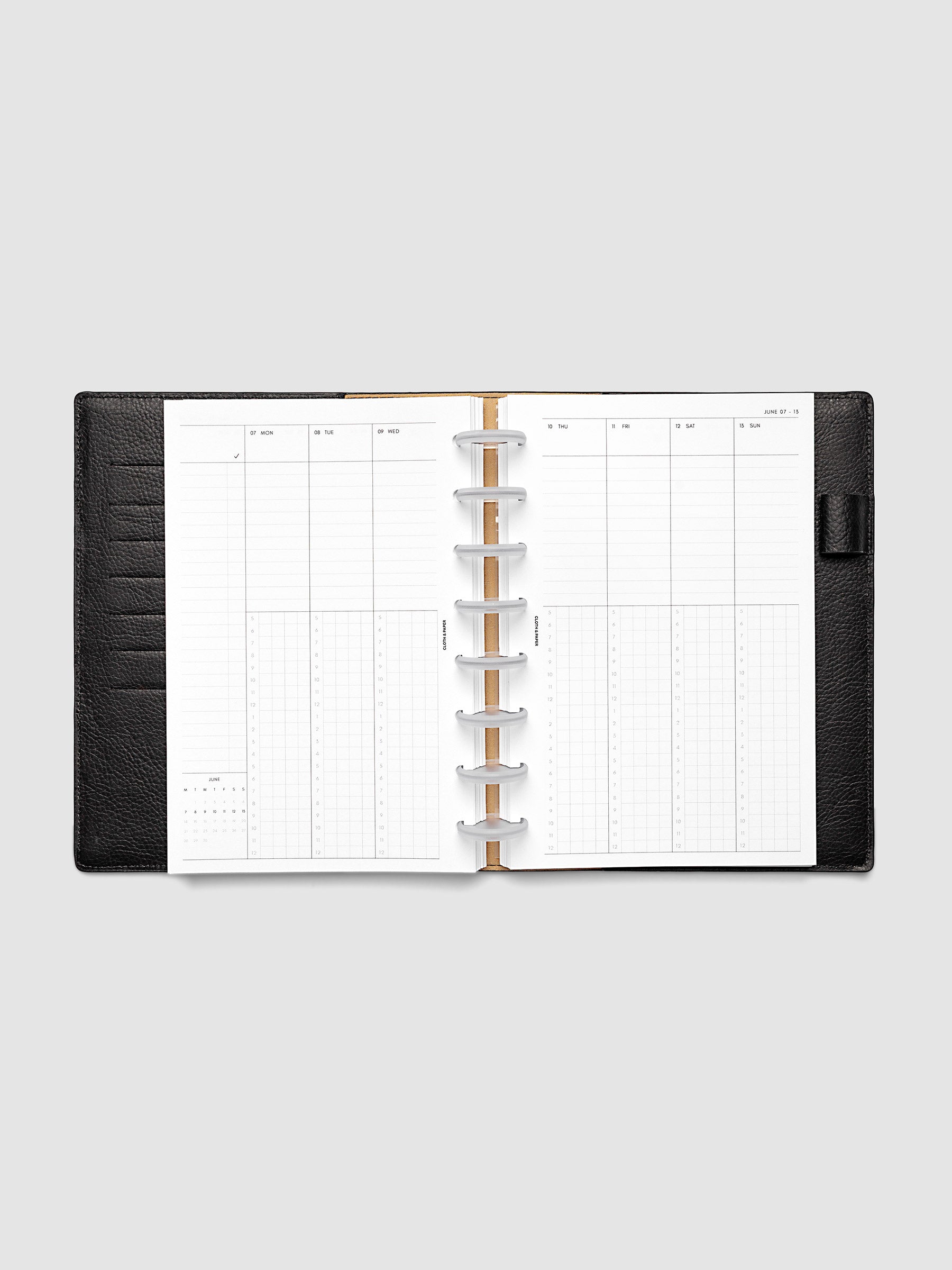 Half Letter 8-Disc Punch weekly time block spread showing left and right pages in a planner