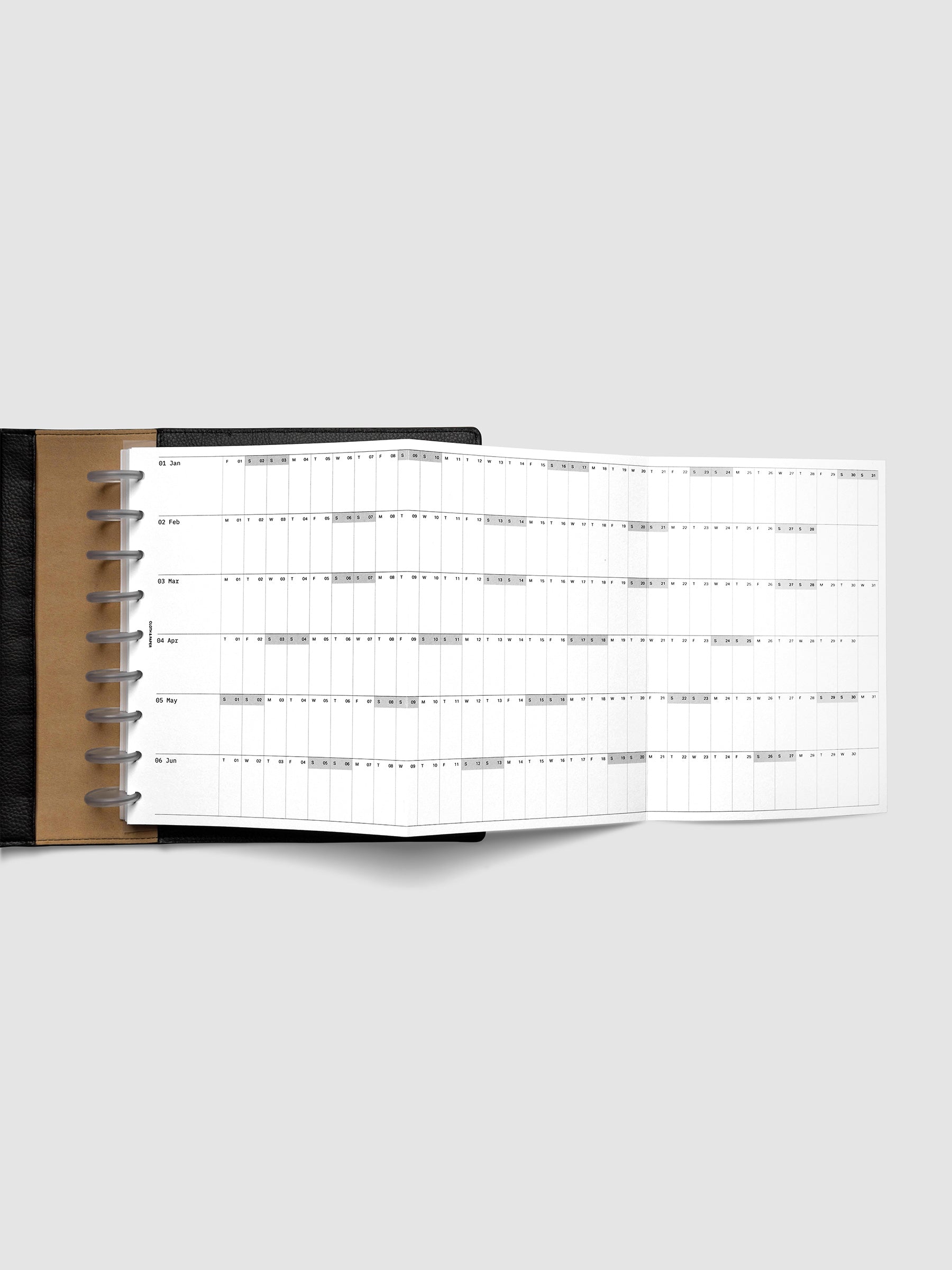 2027 Dated Fold Out Insert fully unfolded inside a HP Classic 9-Disc Punch discbound planner, showing six months of dated calendar boxes across one side.