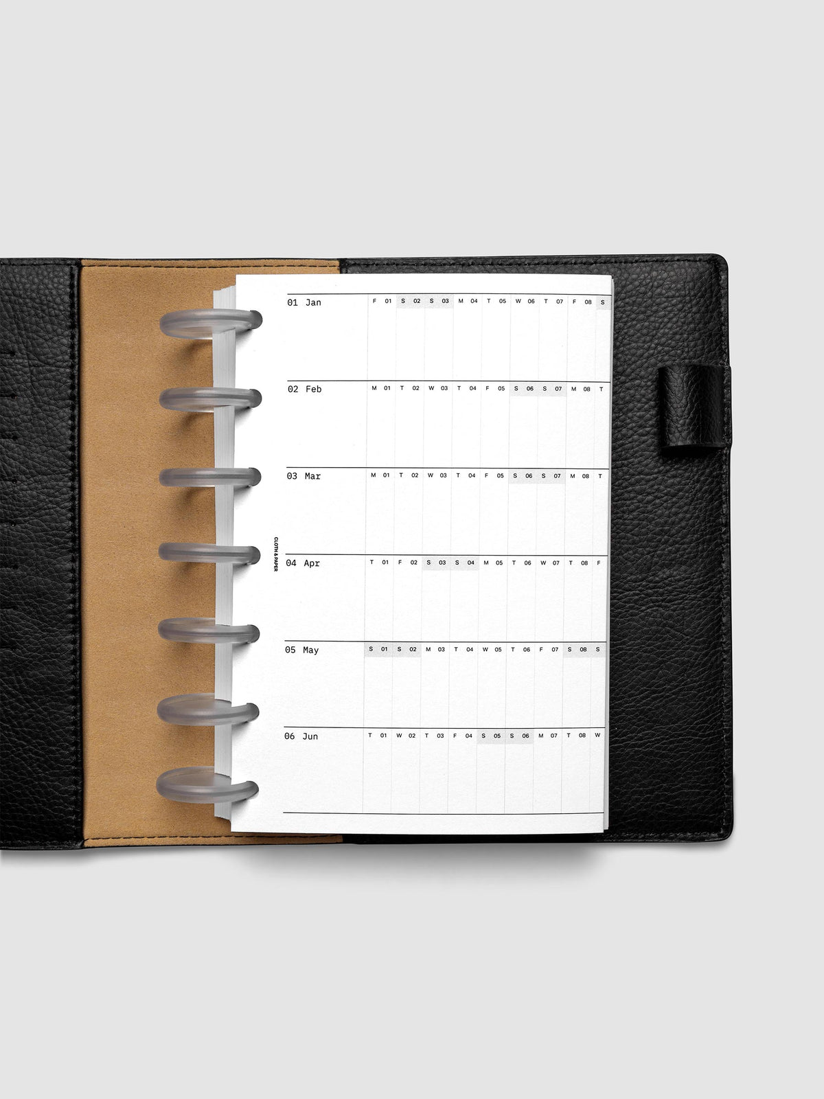 2027 Dated Fold Out Insert tucked into a HP Mini 7-Disc Punch discbound planner, shown closed.