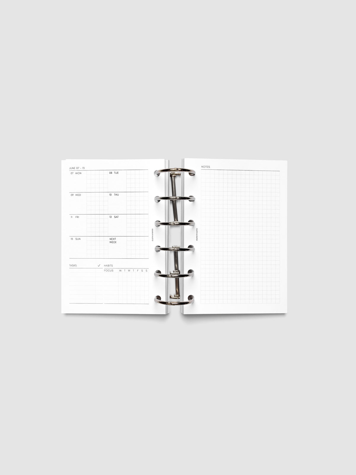 Open planner showing the full two-page 2027 Dated Weekly Admin spread in Pocket 6-Ring Punch size, with the weekly overview and task and habit tracking sections on the left and a graph notes layout on the right