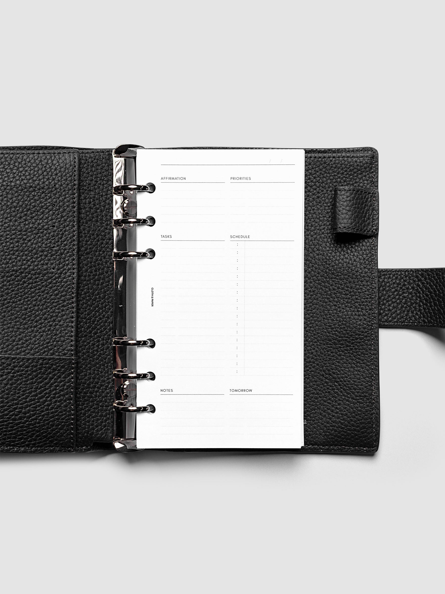 Daily Essentials Planner Inserts shown in size Personal inside a black agenda.