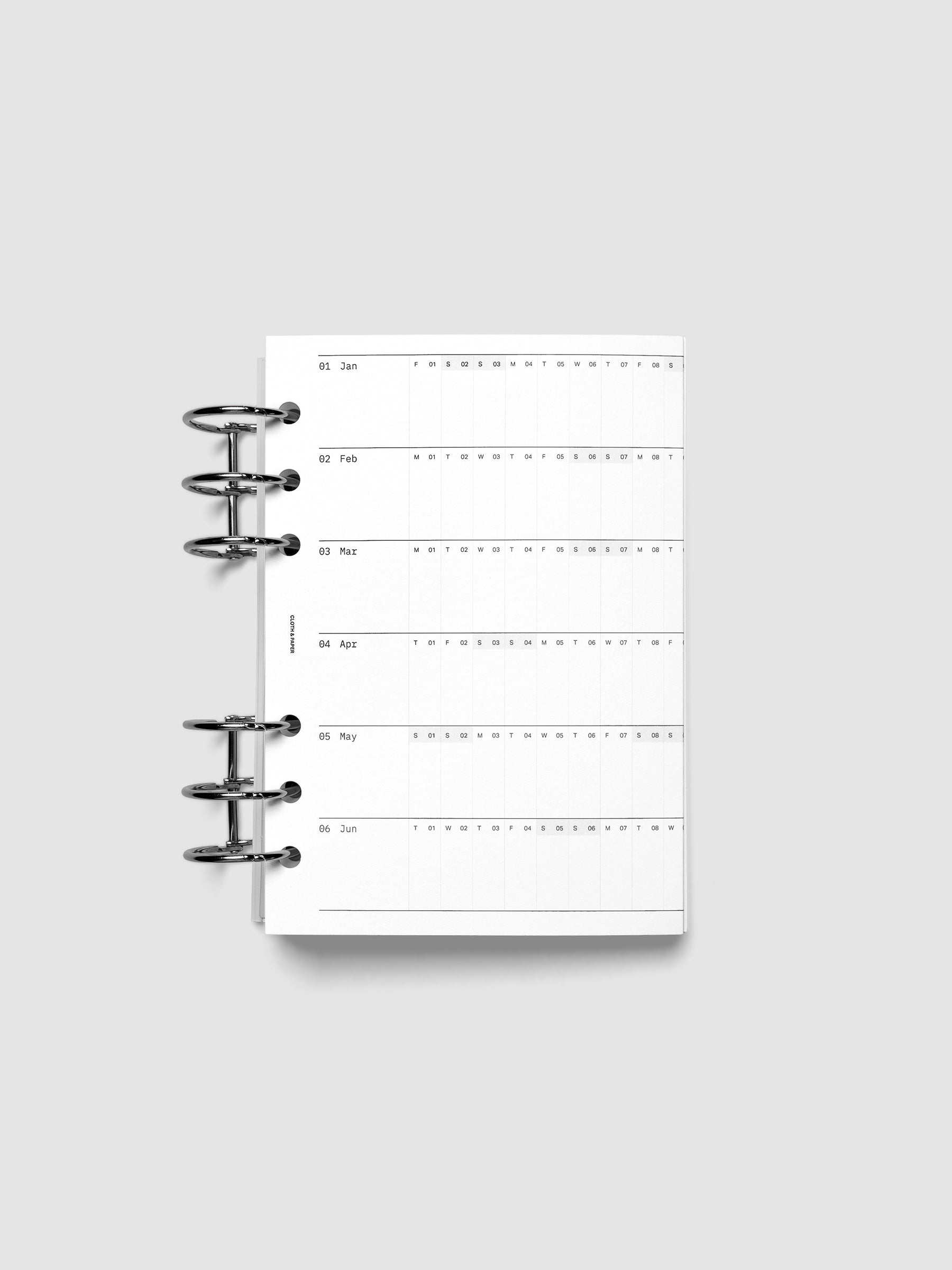 2027 Dated Fold Out Insert tucked into a Personal Wide 6-Ring Punch 6-ring planner, shown closed.
