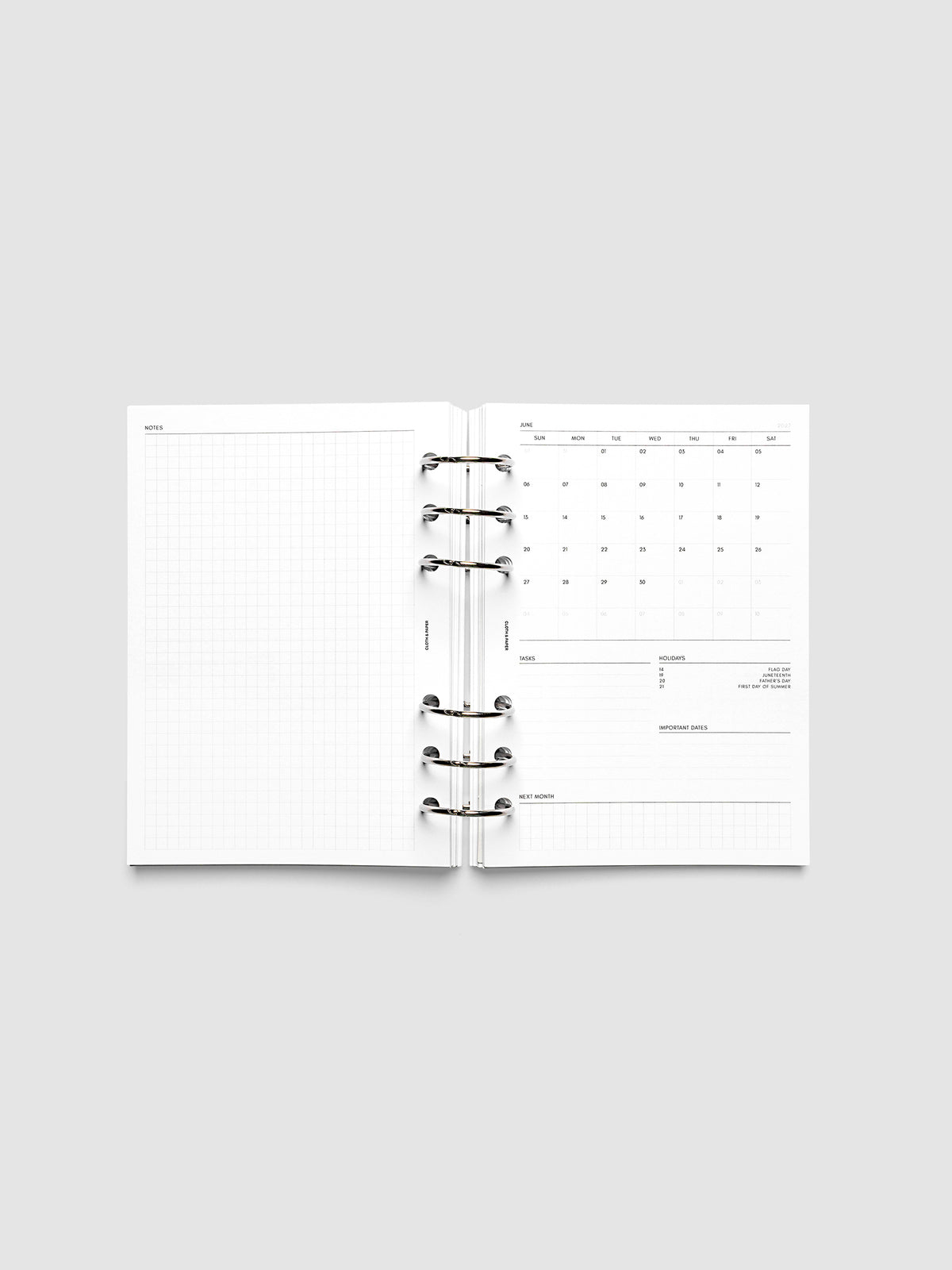 2027 Dated Monthly Admin Inserts open inside a Personal Wide 6-Ring Punch 6-ring planner, showing the fully open graph left page alongside the Sunday start monthly calendar, task section, holiday reference, important dates, and next month preview on the right.