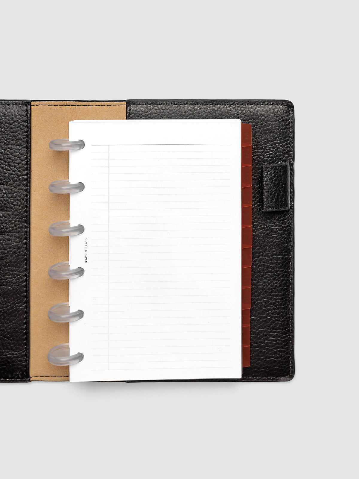 CP Petite 6-Disc Punch Ultra-Thin Monthly Dividers in deep orange shown tabbed inside a planner
