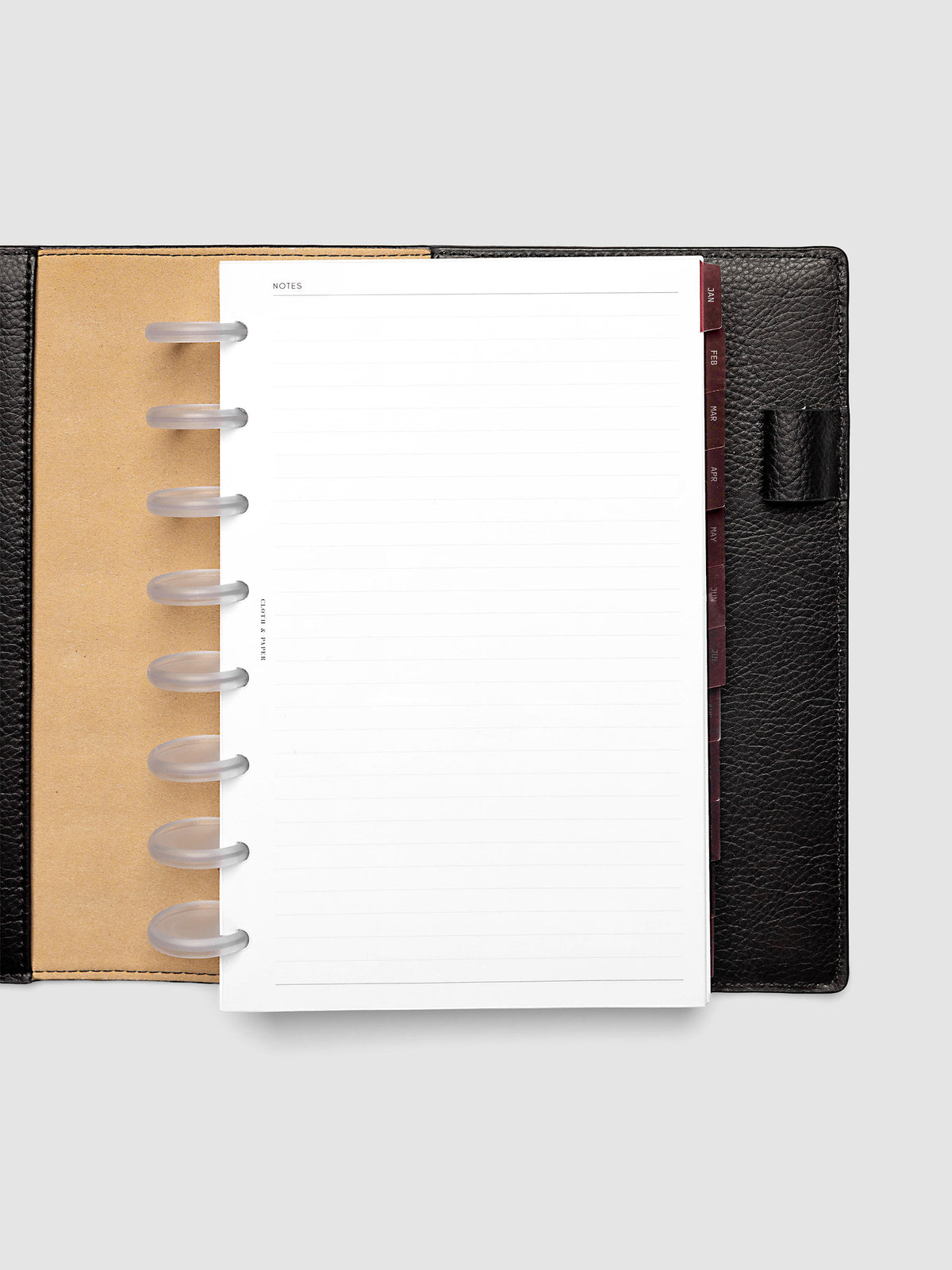 Half Letter 8-Disc Punch Ultra-Thin Monthly Dividers in deep red shown tabbed inside a planner