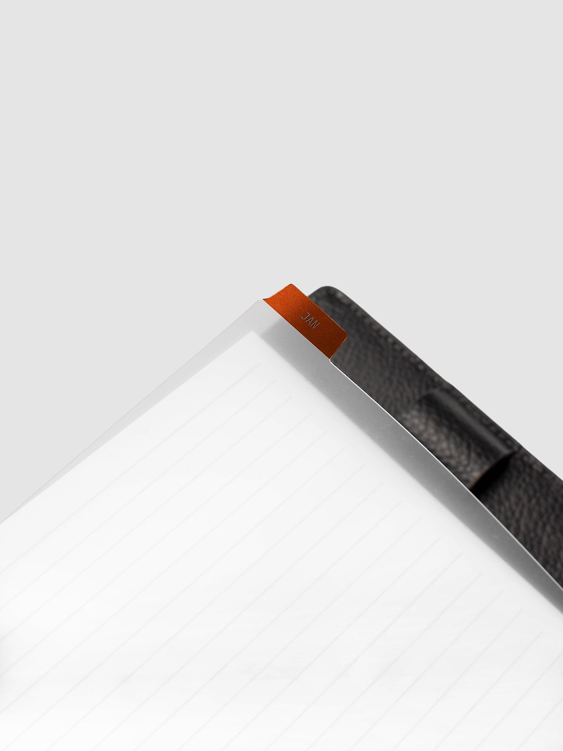 Close-up of deep orange monthly divider lifted from Half Letter 8-Disc Punch planner showing colored background and clear knockout month text