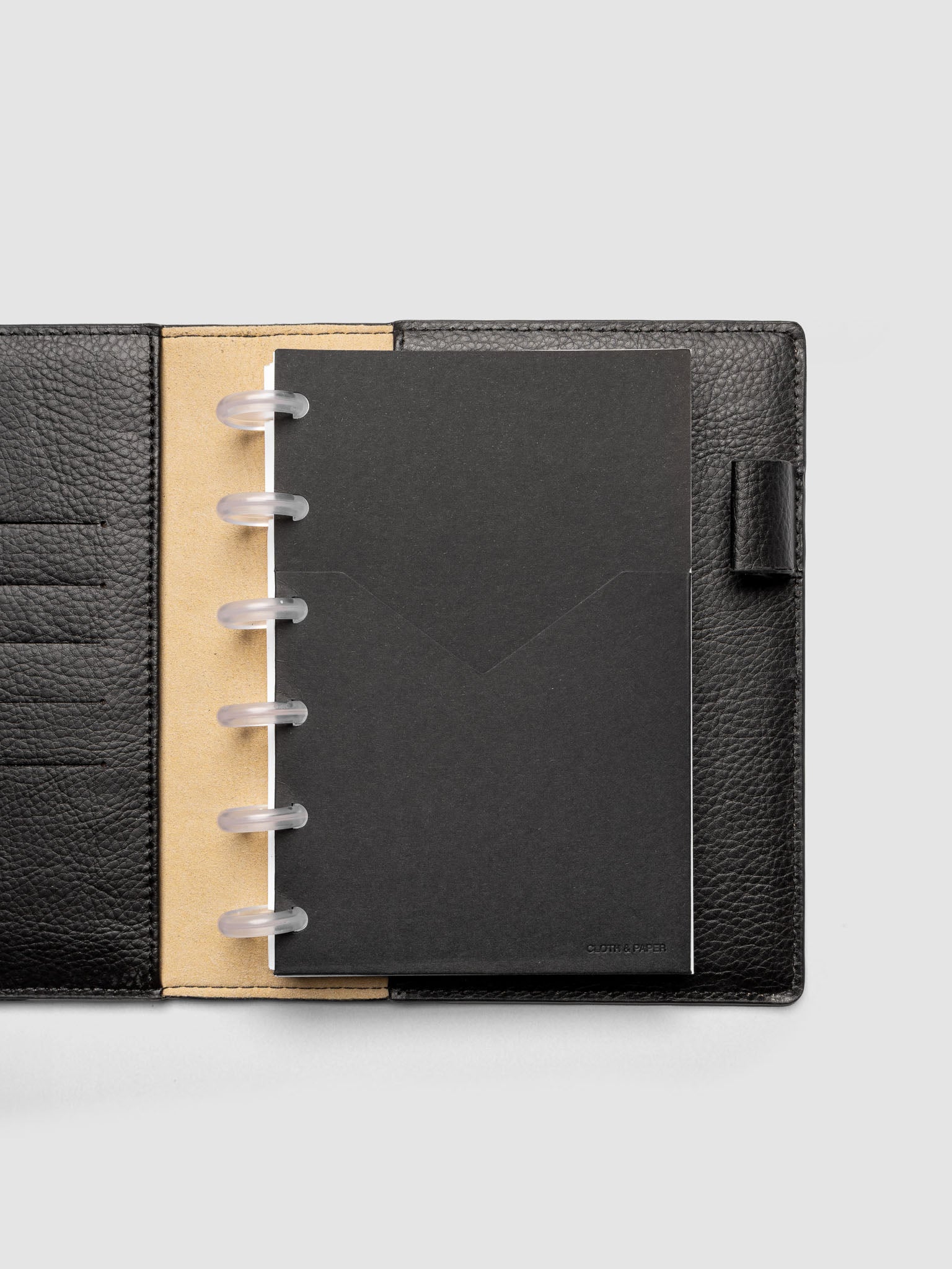 Black planner paper pocket folder shown inside a planner in size CP Petite 6-Disc Punch