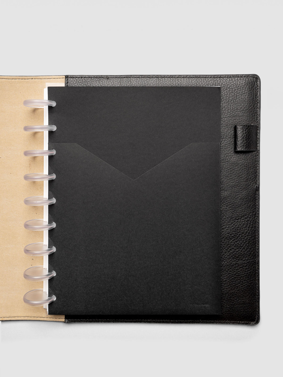 Black planner paper pocket folder shown inside a planner in size HP Classic 9-Disc Punch