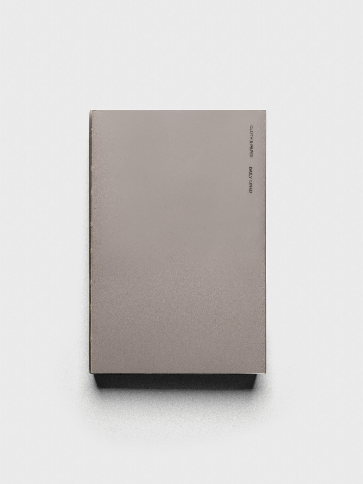 Perfect Bound Notebook | CP Petite | Daily  Lined | Verona shown closed, laying flat, on a neutral background.