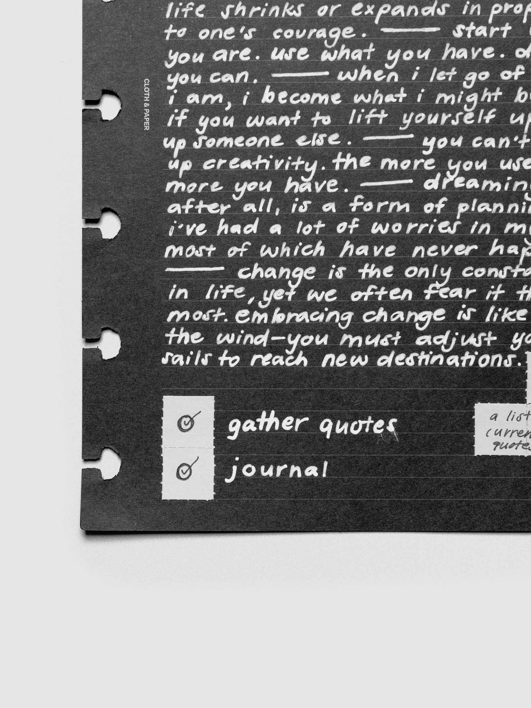 Grey tear-off stickers applied to a black planner insert with white writing