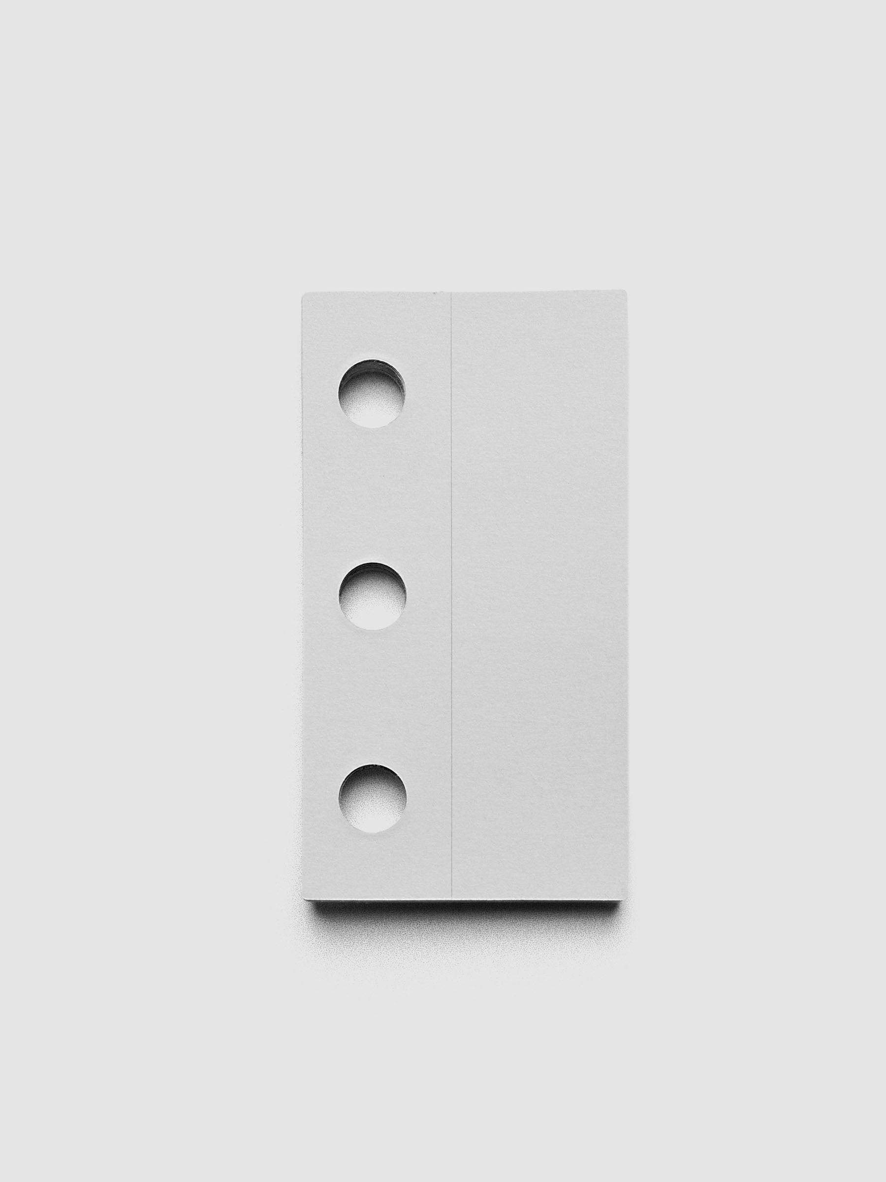 Single ring system punch sticker against a grey background.