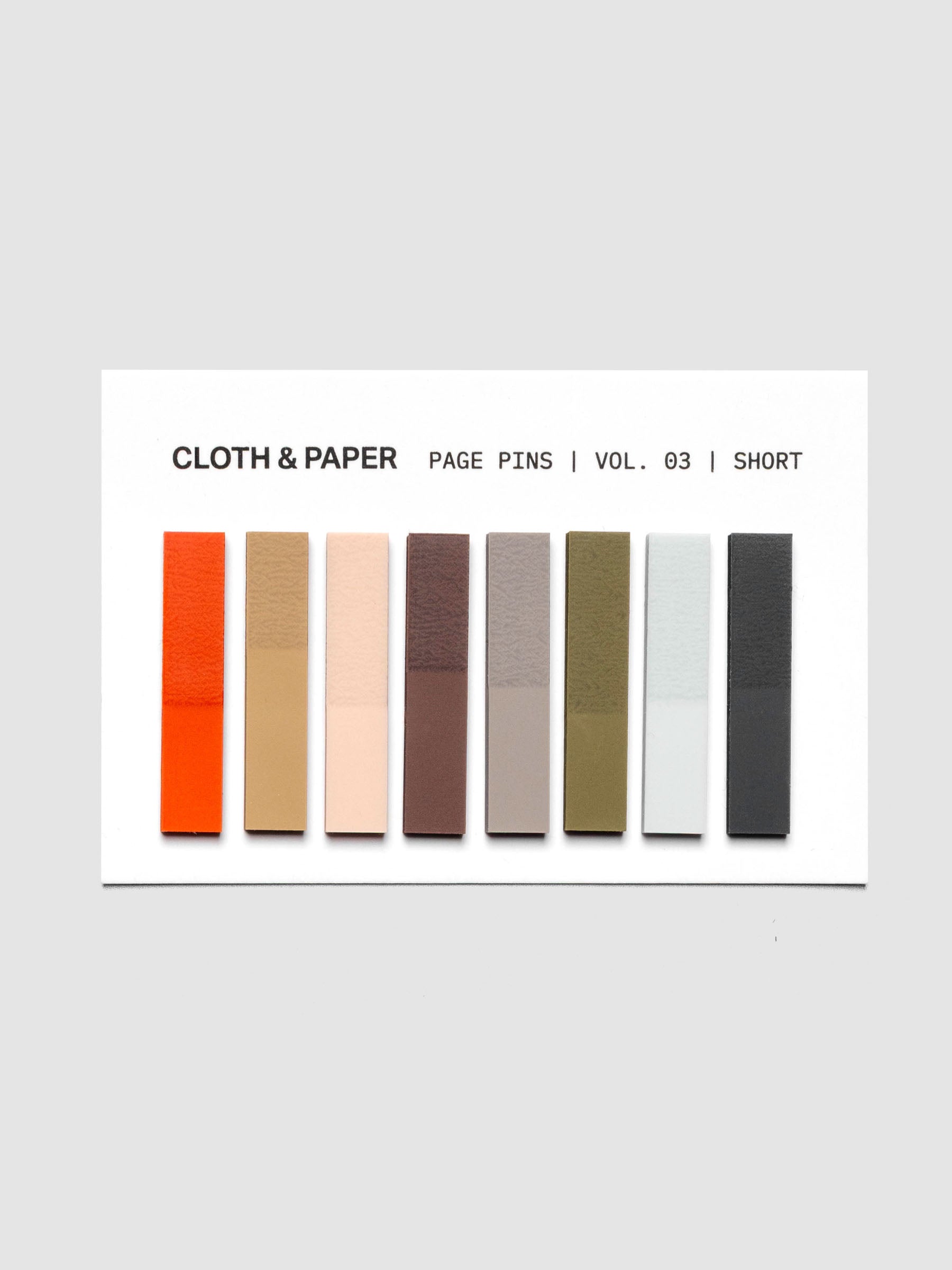 Page Pins Short on backing card, eight colorways: deep orange, warm light brown, peach, burgundy, grey, olive, light blue, and navy