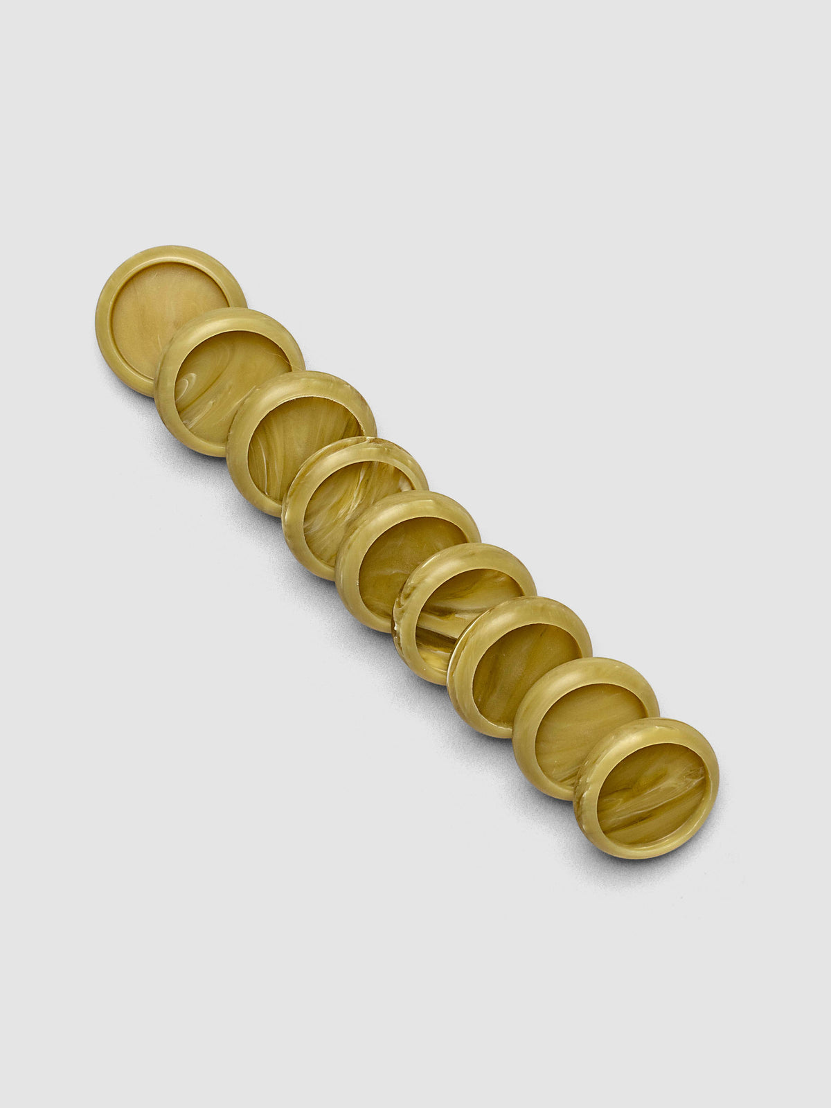 Nine Carrara Verde 0.75" planner discs arranged in a row, showing the bold green marbled printed acrylic finish