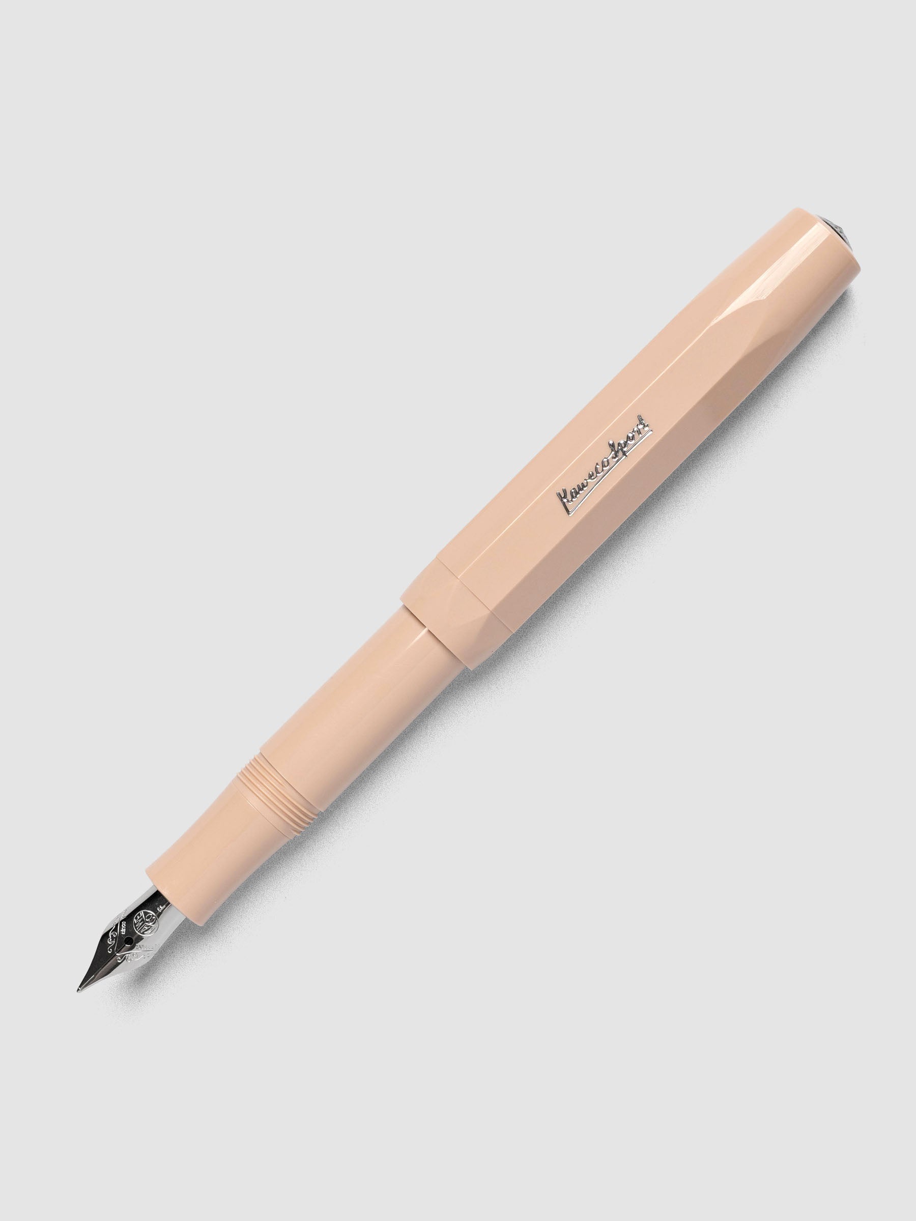 Warm beige fountain pen with a fine nib shown with cap posted.