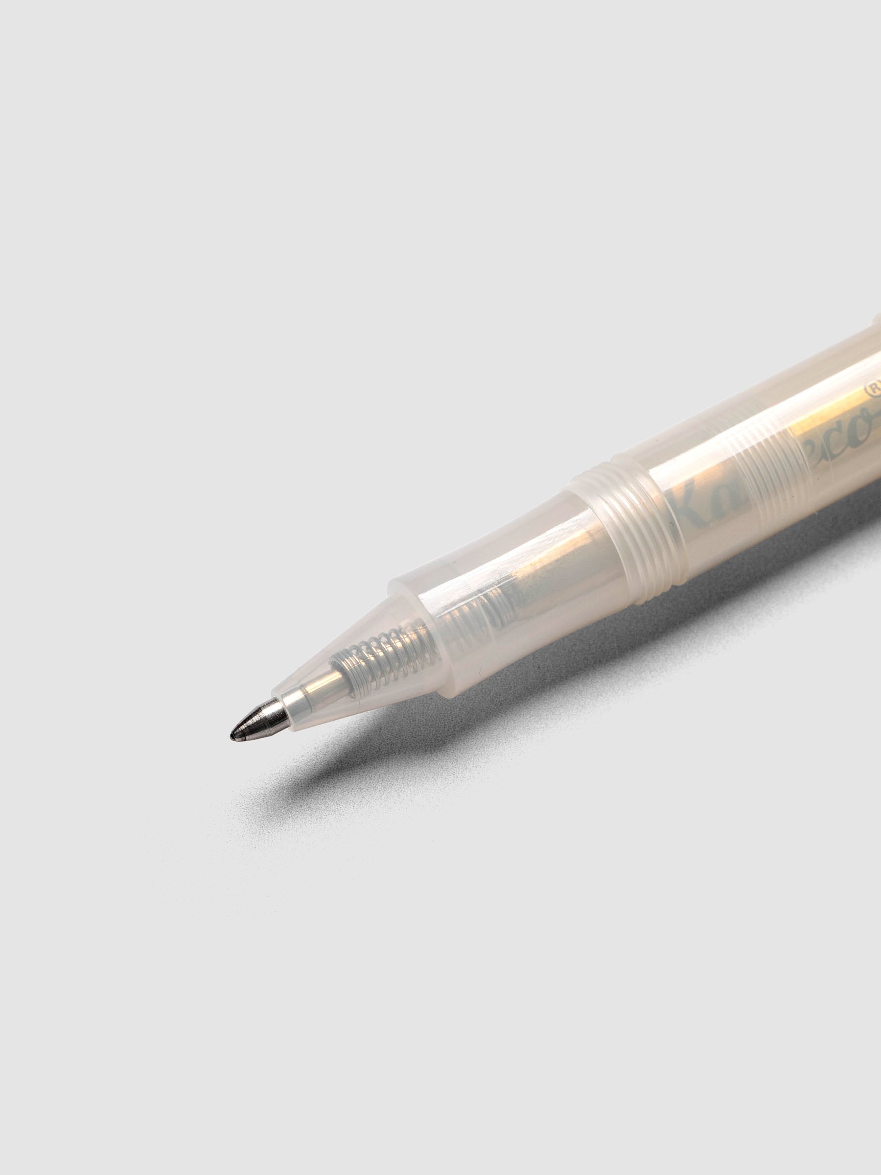 Close up view of the rollerball tip on a clear pen.