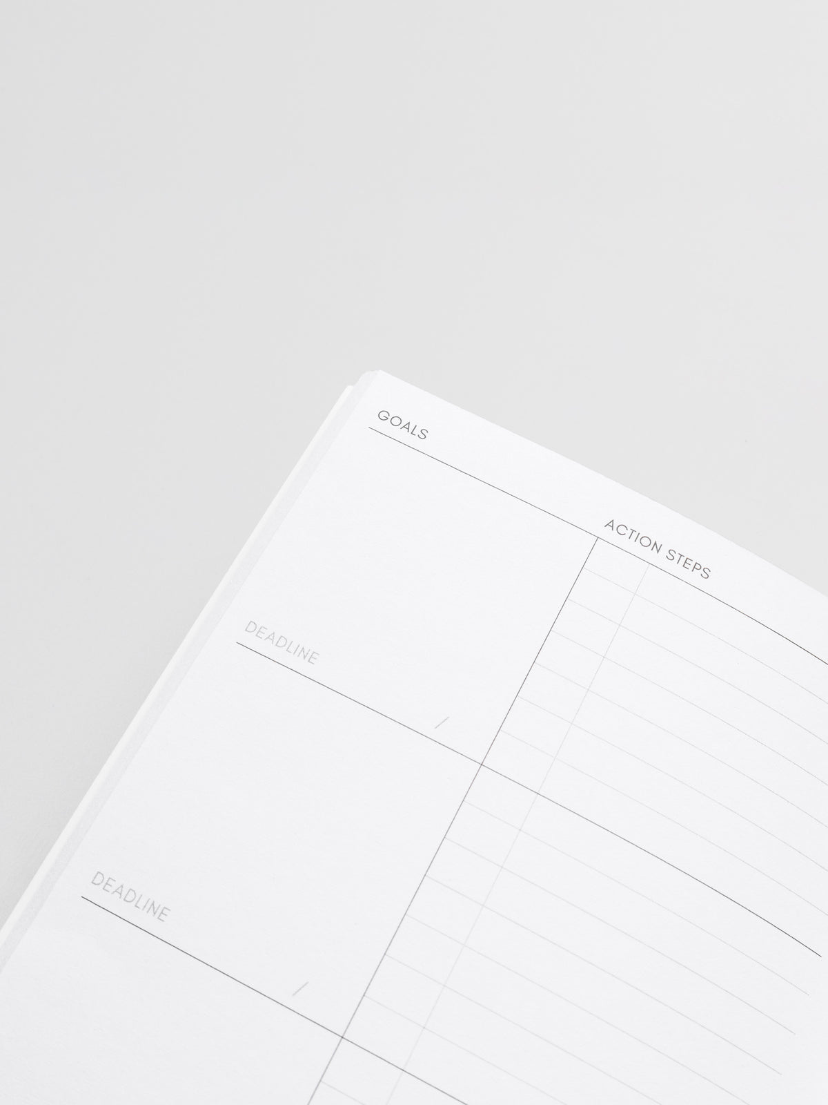Interior of Goal Tracking Travel Notebook in size A5 Slim displaying a two column layout in blank and task with fields for goals, deadlines, and action steps.