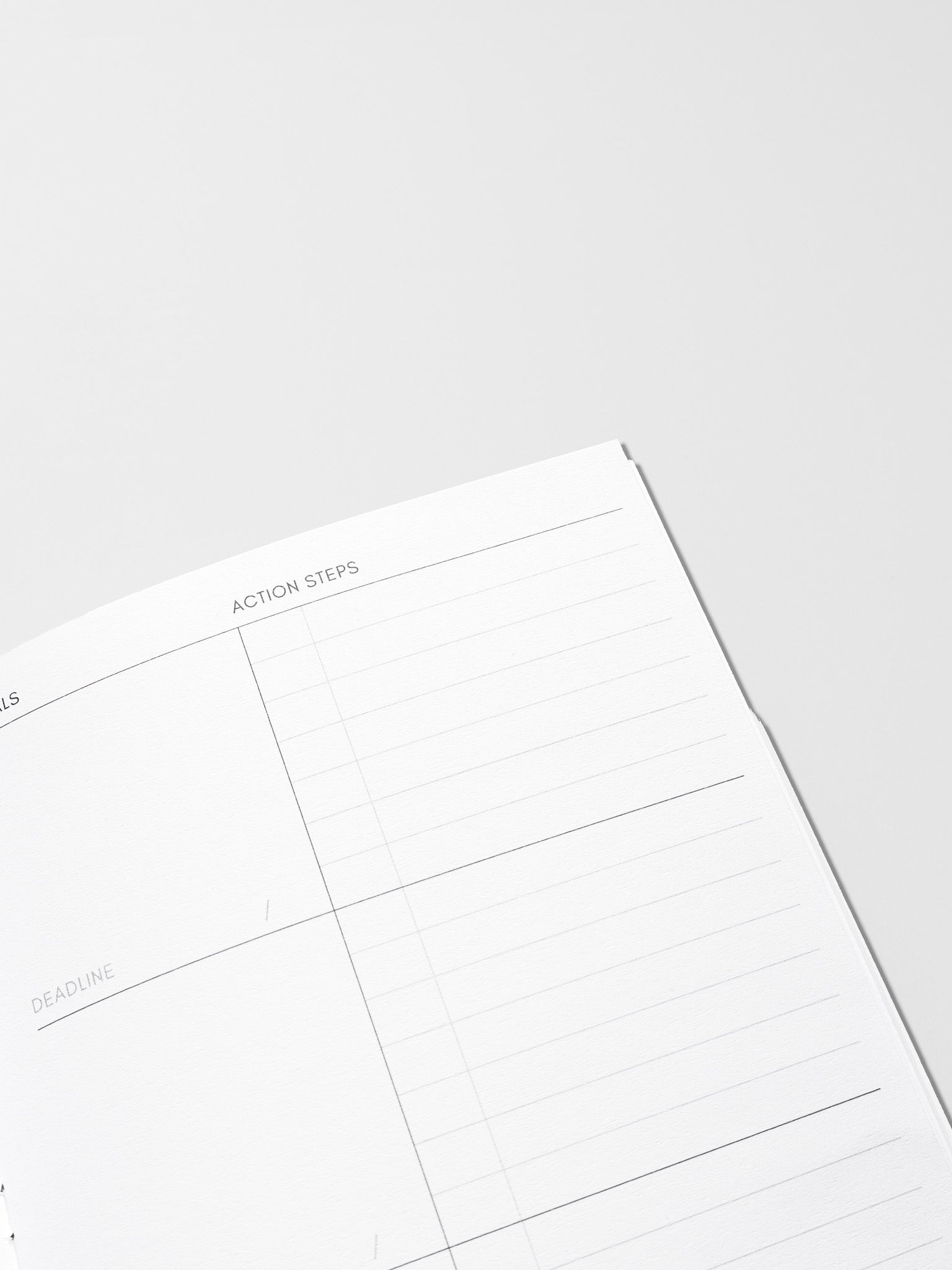 Interior of Goal Tracking Travel Notebook in size A5 Slim displaying a two column layout in blank and task with fields for goals, deadlines, and action steps.