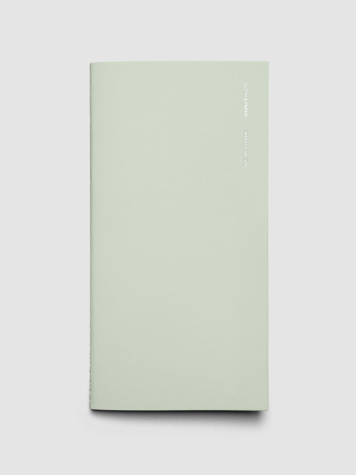 Travel Notebook in size A5 Slim in color Matcha with Weekly Graph pages shown closed.