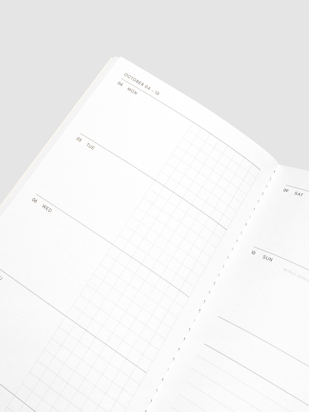 Close-up of the top of the left page of the Jul–Dec 2027 Dated Travel Notebook, showing the split daily columns with open space and graph sections