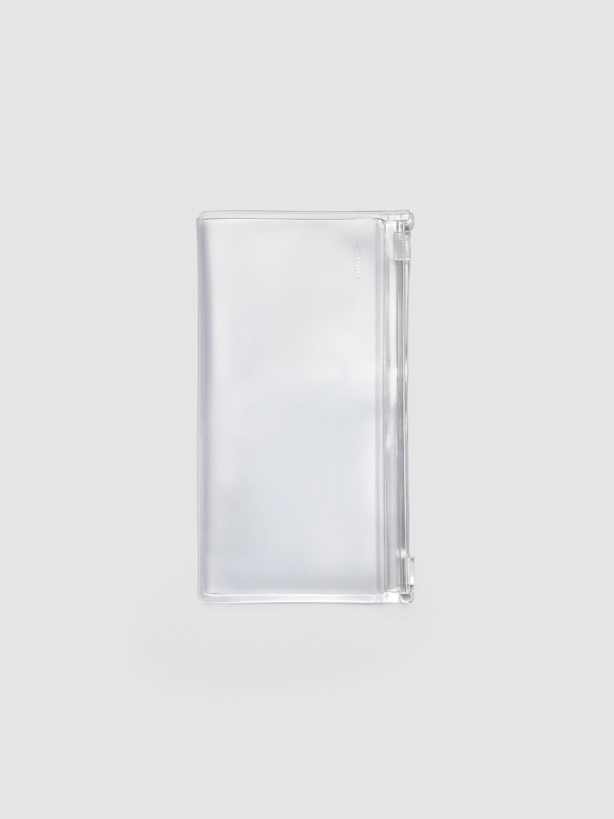 Pocket Plus travel notebook storage holder in clear frosted plastic, closed, showing silver foil logo