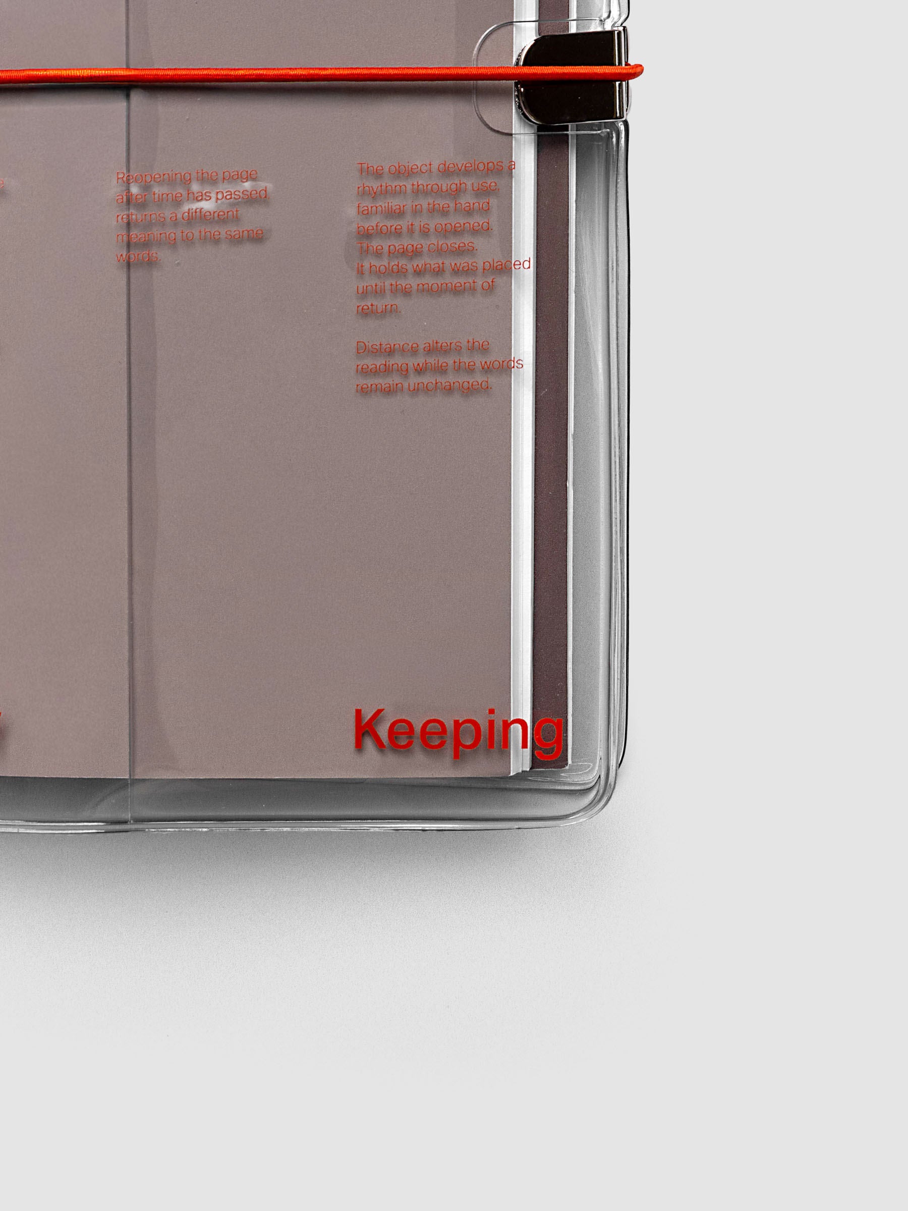 Close-up of the bottom right corner of the Act of Keeping Travel Notebook Cover in A5 Slim size with travel notebooks inside, showing deep orange band detail