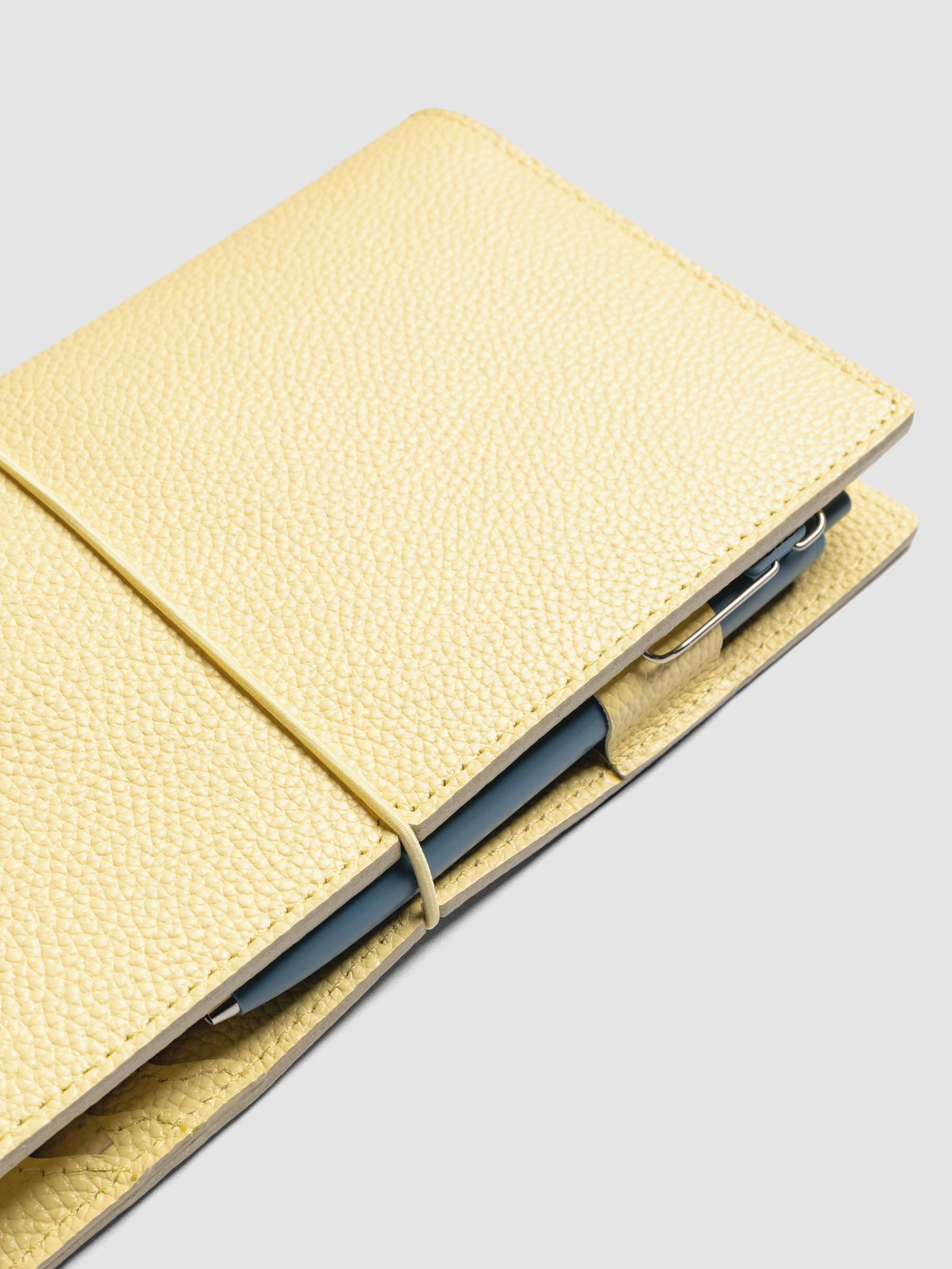 Butter yellow leather travel notebook cover in size A5 Slim shown closed.