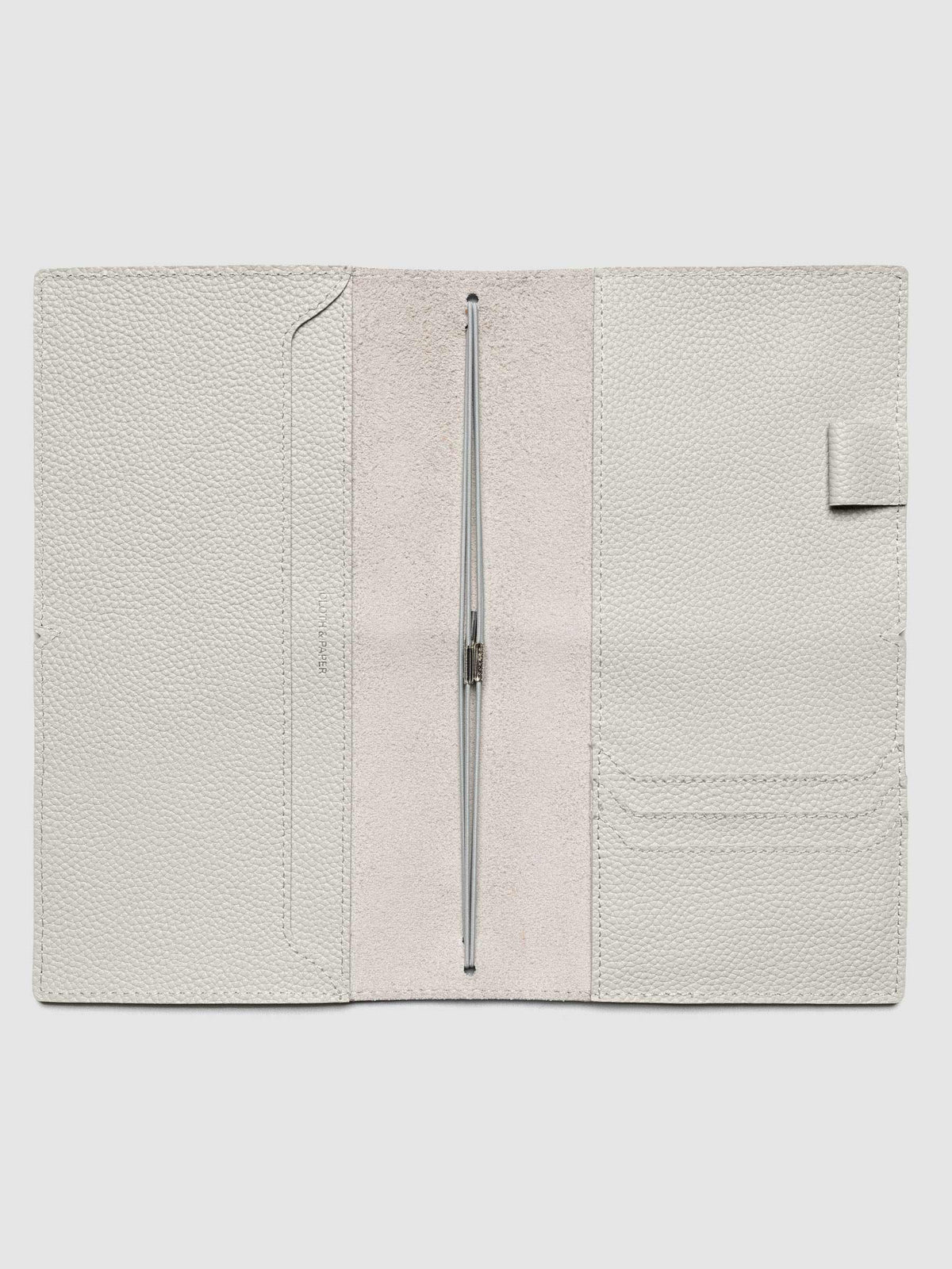 Light grey leather travel notebook cover in size A5 Slim shown open with interior pockes and elastic bands.