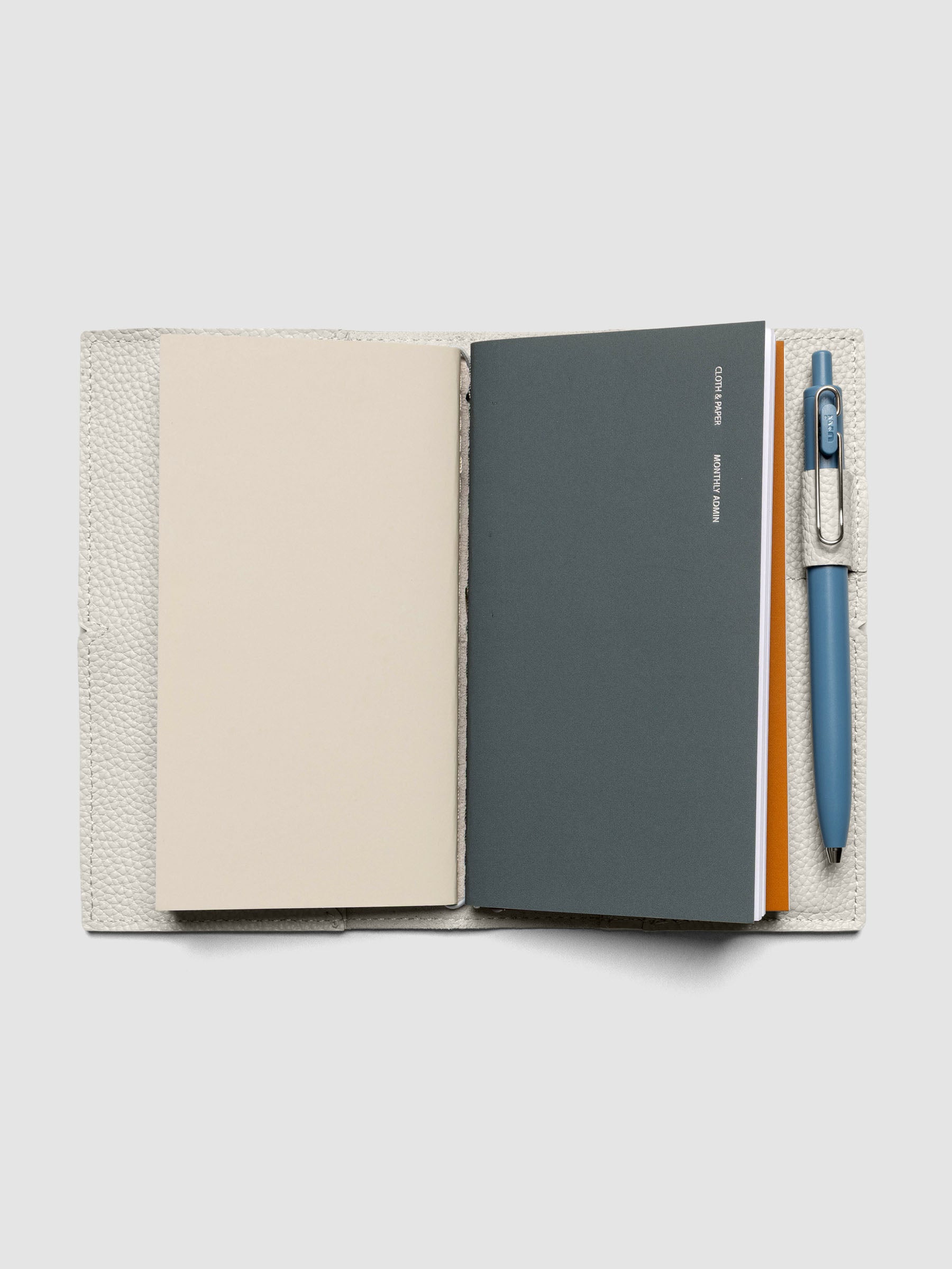 Light grey leather travel notebook cover in size Pocket Plus shown closed.