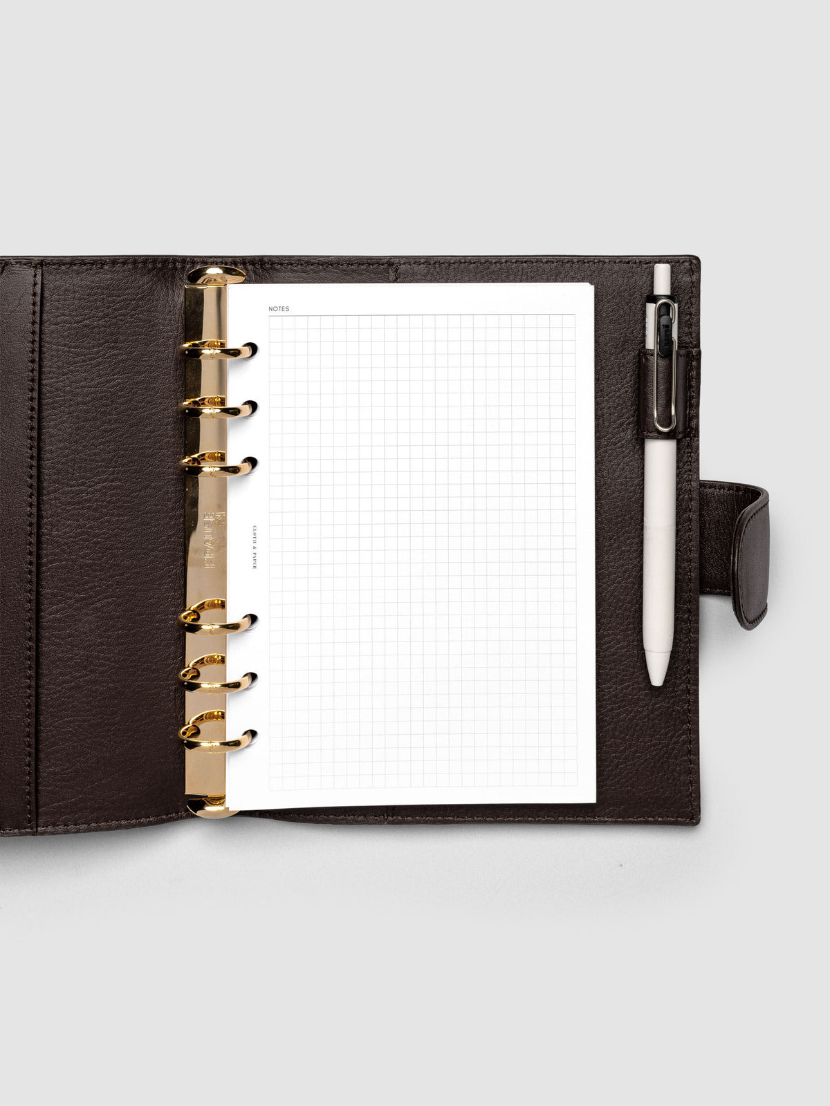 Open dark brown genuine leather Personal Wide 6-ring planner cover with inserts inside, gold Krause rings visible