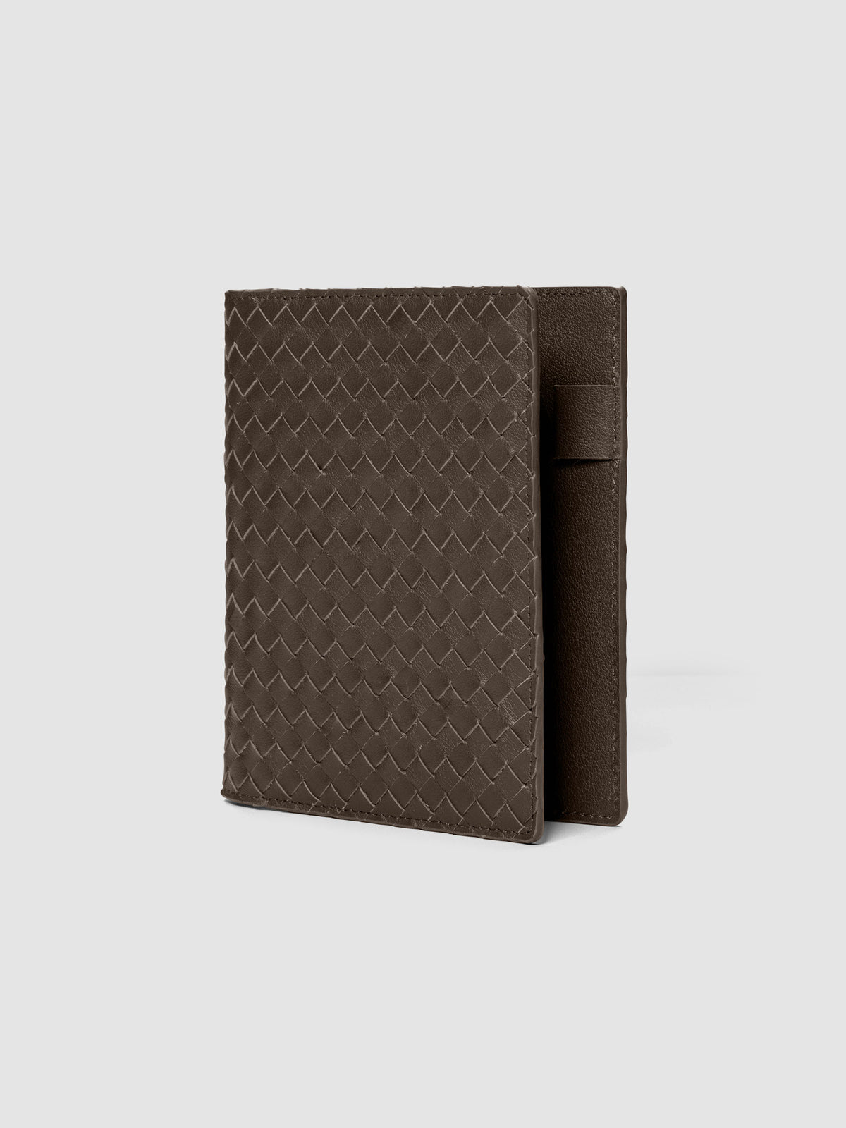 Dark brown woven leather planner cover shown standing at an angle.