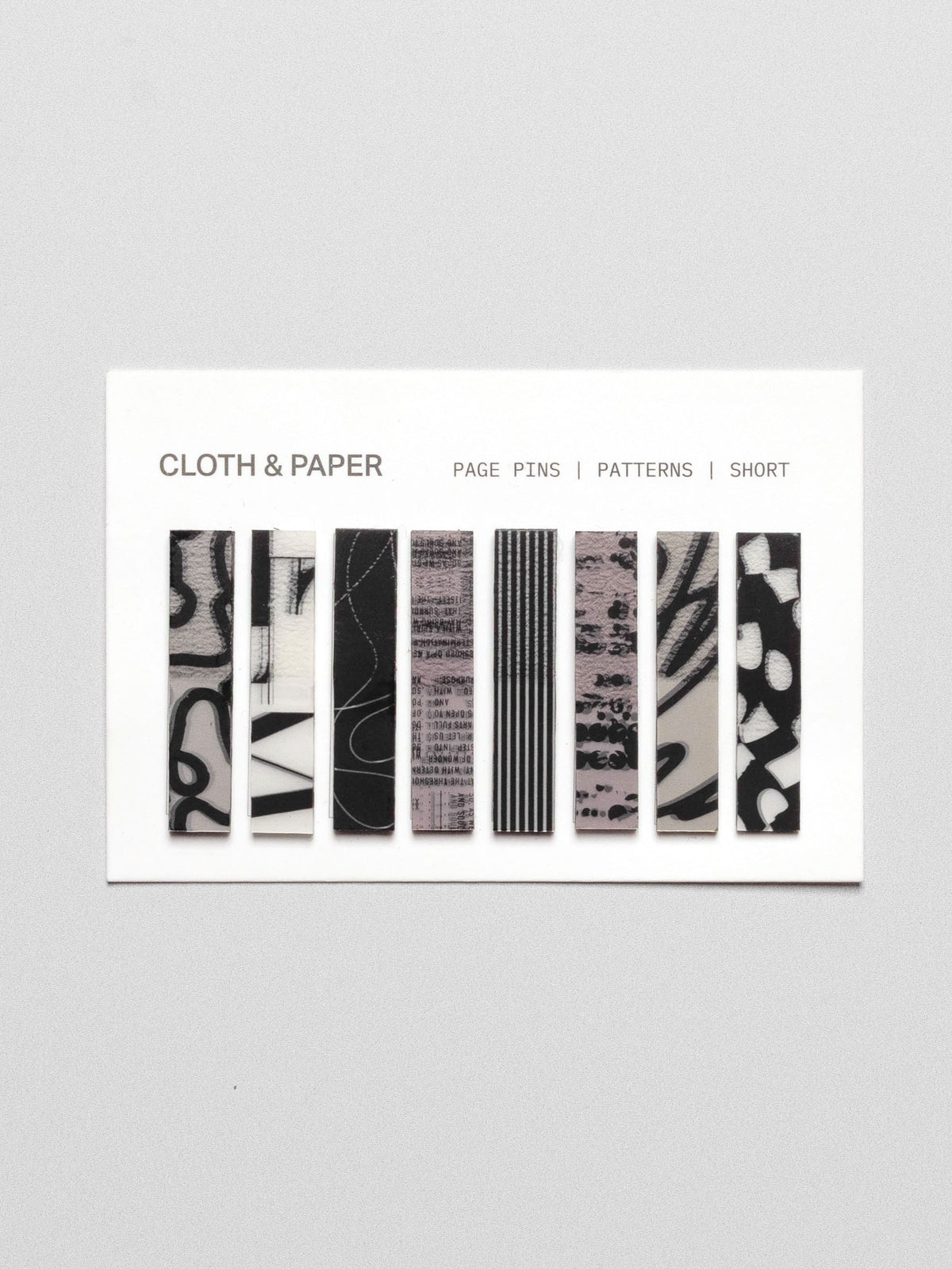 Short page pins displayed in their packaging on a neutral background.