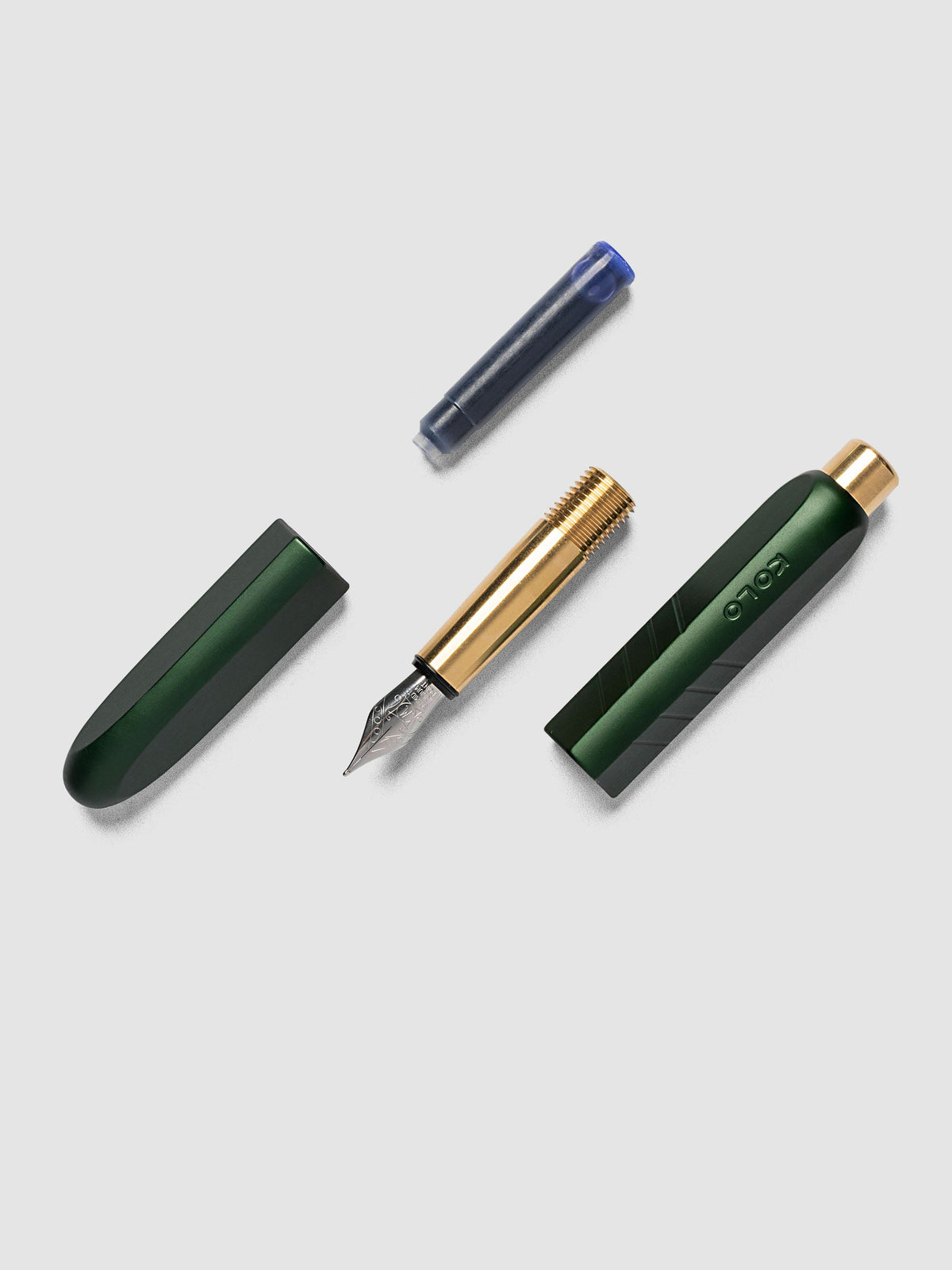Kolo Tino Fountain Pen in Anodized Aluminum Verdant fully disassembled showing cap, nib section, barrel, and ink cartridge