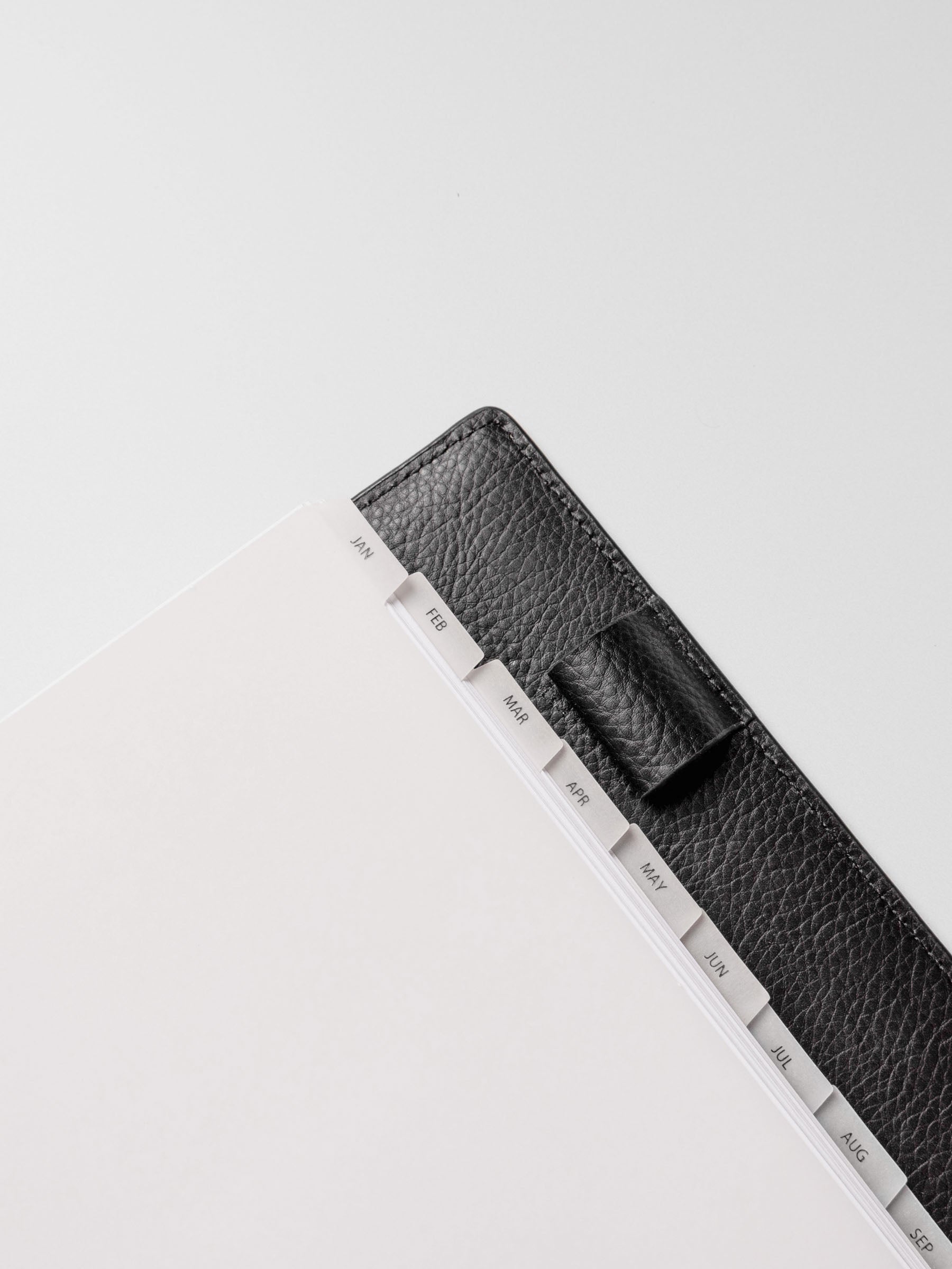Half Letter vellum dividers shown bound with rings in an agenda.
