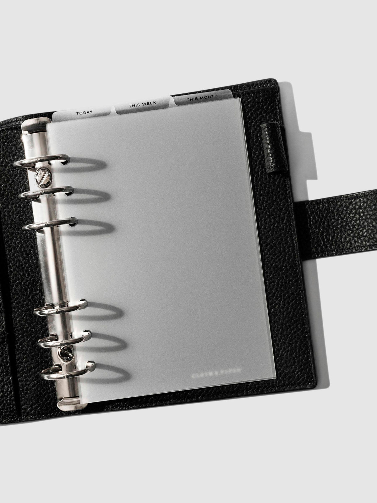 Personal Wide Black Foil Cadence Tab Dividers displayed in a black leather planner.