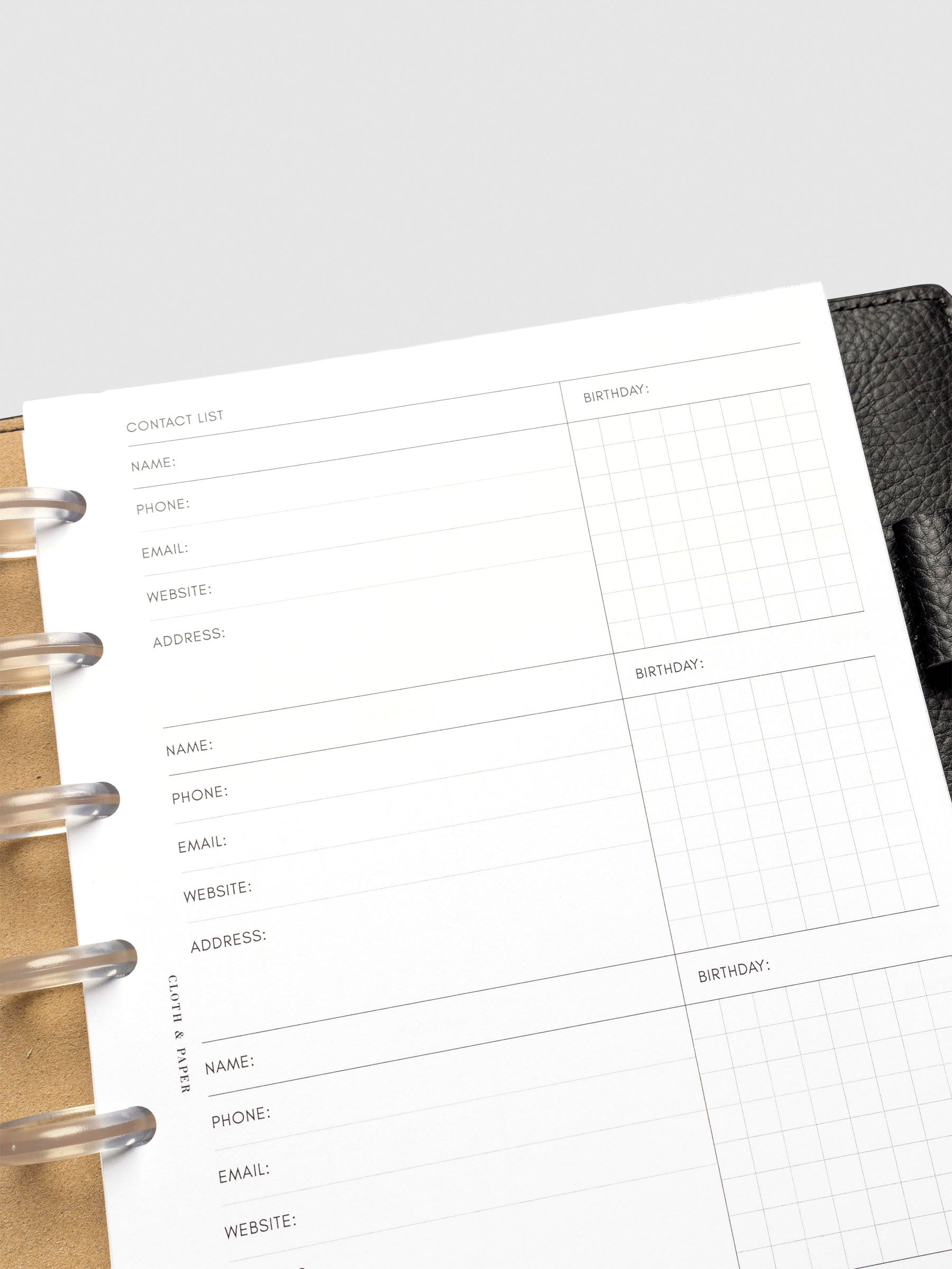 Refreshed Contact List Planner Inserts styled inside a black leather agenda. 