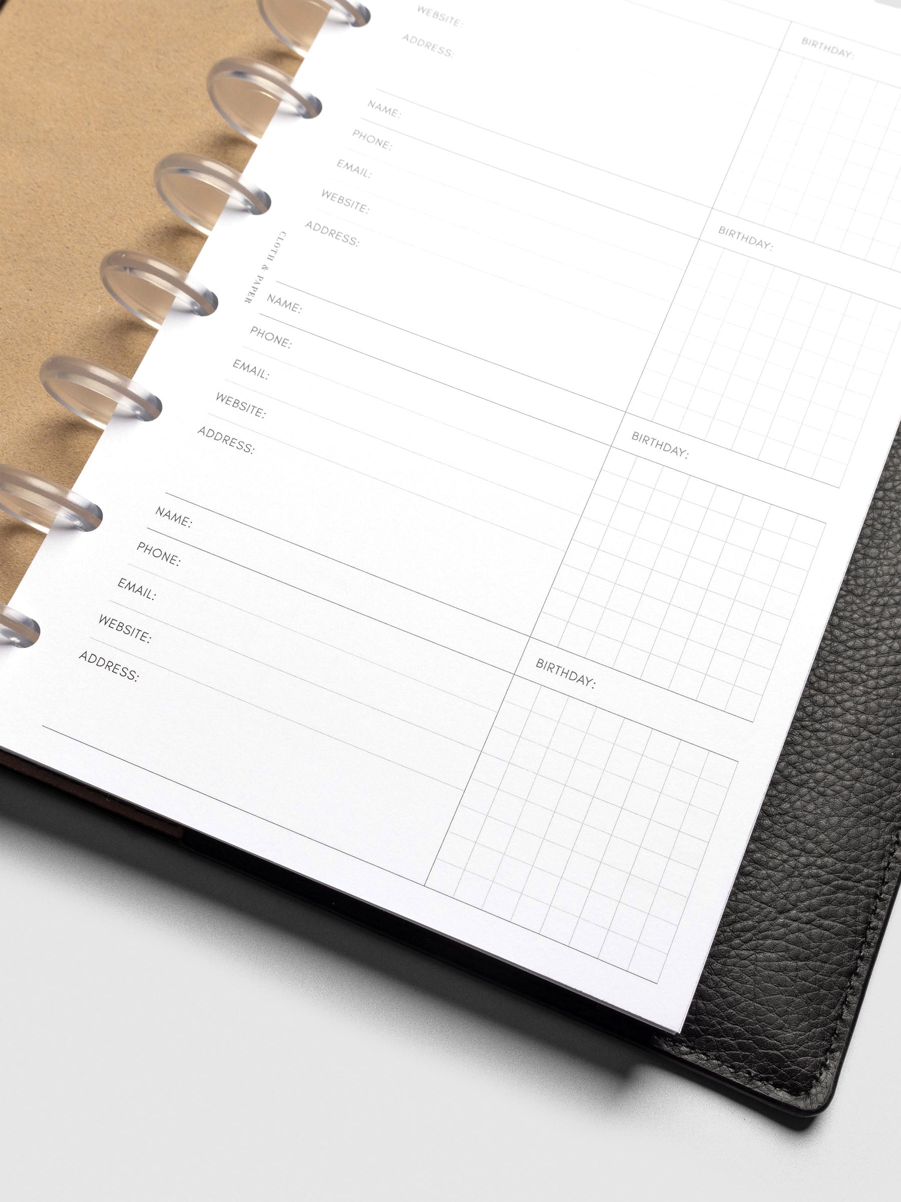 Refreshed Contact List Planner Inserts styled inside a black leather agenda. 